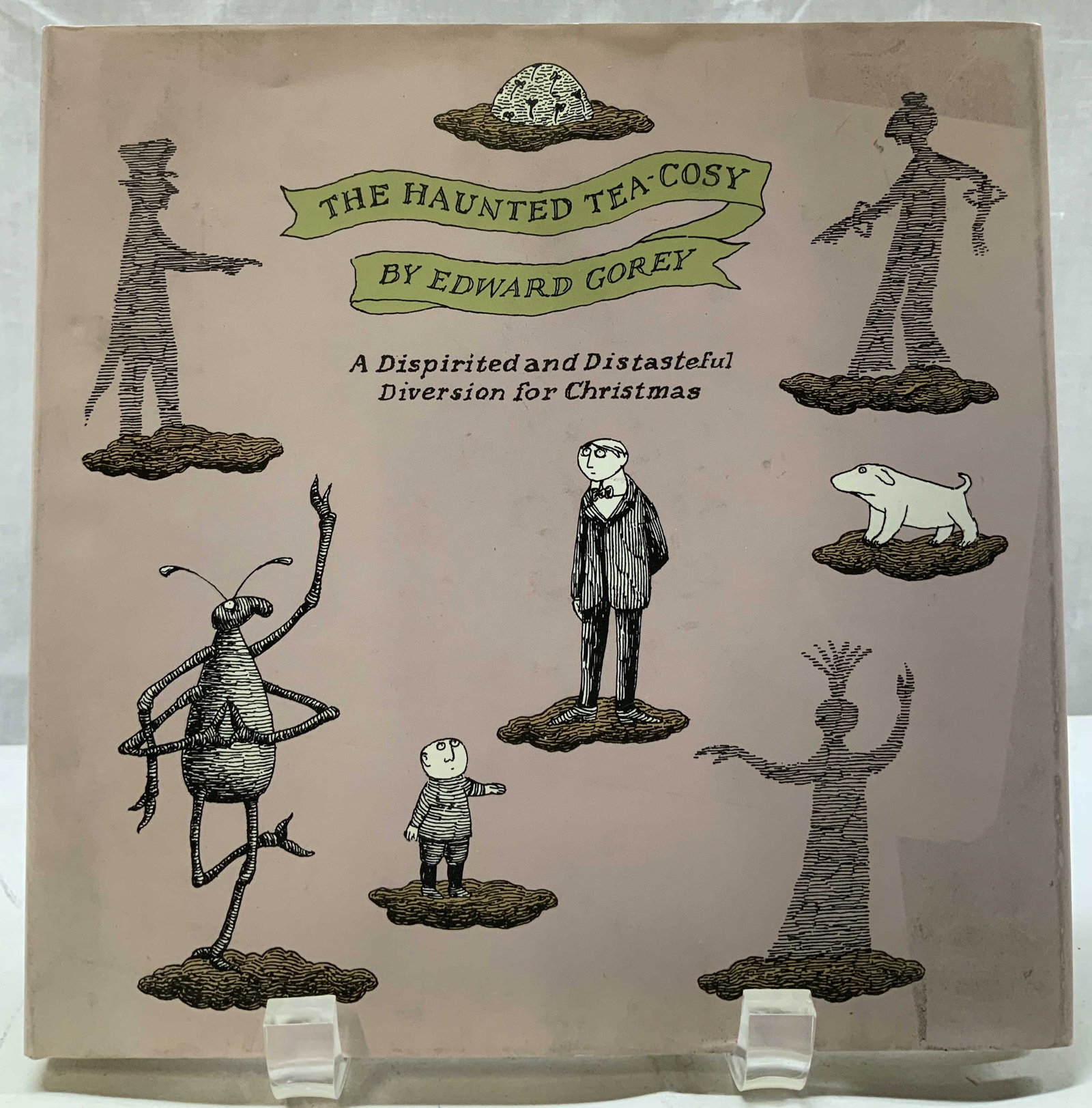 1997 Haunted Tea-Cosy Illustr Book GOREY SINGAPORE: 1997 Haunted Tea-Cosy Illustr Book GOREY SINGAPORE The Haunted Tea-Cosy book by Edward Gorey. A dispirited & distasteful diversion for Christmas. COPYRIGHT 1997 by Edward Gorey. Printed & bound in Sin