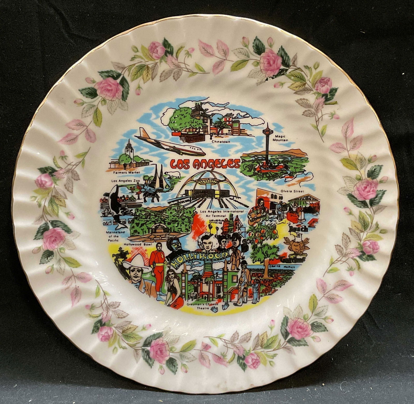Vtg Creative LosAngeles Souvenir China Plate Japan: Vintage Creative fine china souvenir plate, Los Angeles. Landmarks and celebrity motifs with floral border and gilt scalloped edge. Signed. Measures approx 10 inches wide. Some wear including scratche