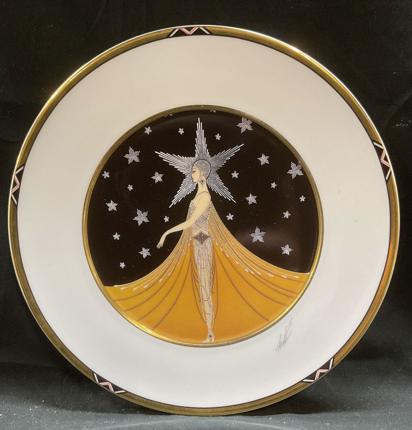 1990 ERTE SevenArts Lmt NY China Plate W Germany: Vintage 1990 New York, New York fine china charger plate. Design by ERTE for Sevenarts Limited. Made in West Germany. Image of an Art Deco woman in profile wearing beaded gold dress with star headdres