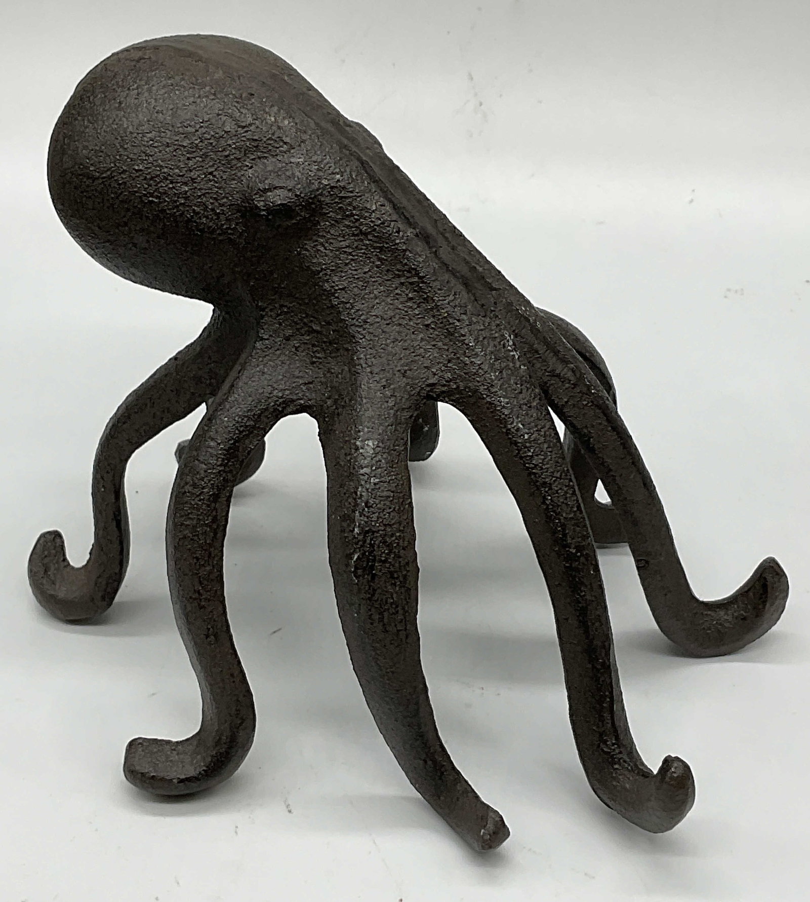 Cast Iron Octopus Figural Paperweight: Cast Iron Octopus Figural Paperweight. Eight legs. Solder present. Measures approx. 4.25H x 5W in. Surface wear consistent with age, use, and exposure. home decor, home accents, homewares, housewares,