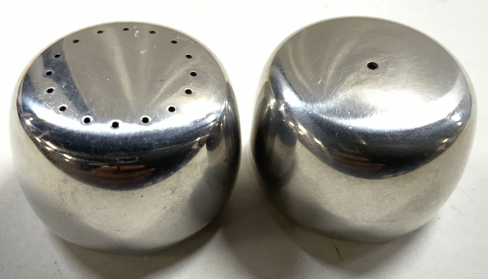 GEORG JENSEN Koppel Stainless S&P Shakers Denmark: Undersides are inscribed GEORG JENSEN MADE IN DENMARK, model 56. Appears to be pebble pattern designed by Henning Koppel. Clean lined modernist form. Lot includes 2 shaker. Each are silver toned Stain