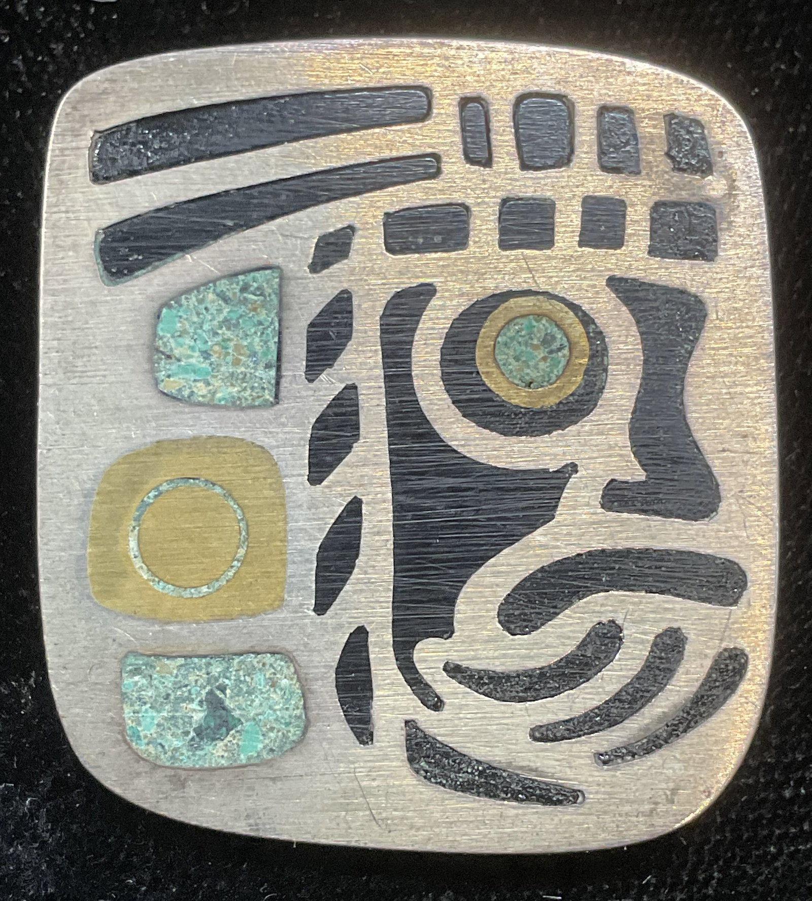 Signed Sterling Silver Turquoise Head Brooch: Signed vintage sterling silver brooch with tribal head motif. Inlaid turquoise and glass. Signed illegibly. Marked sterling. Made in Mexico. Measures approx 1.25 x 1.25 inches. 8.5 grams. Some wear in
