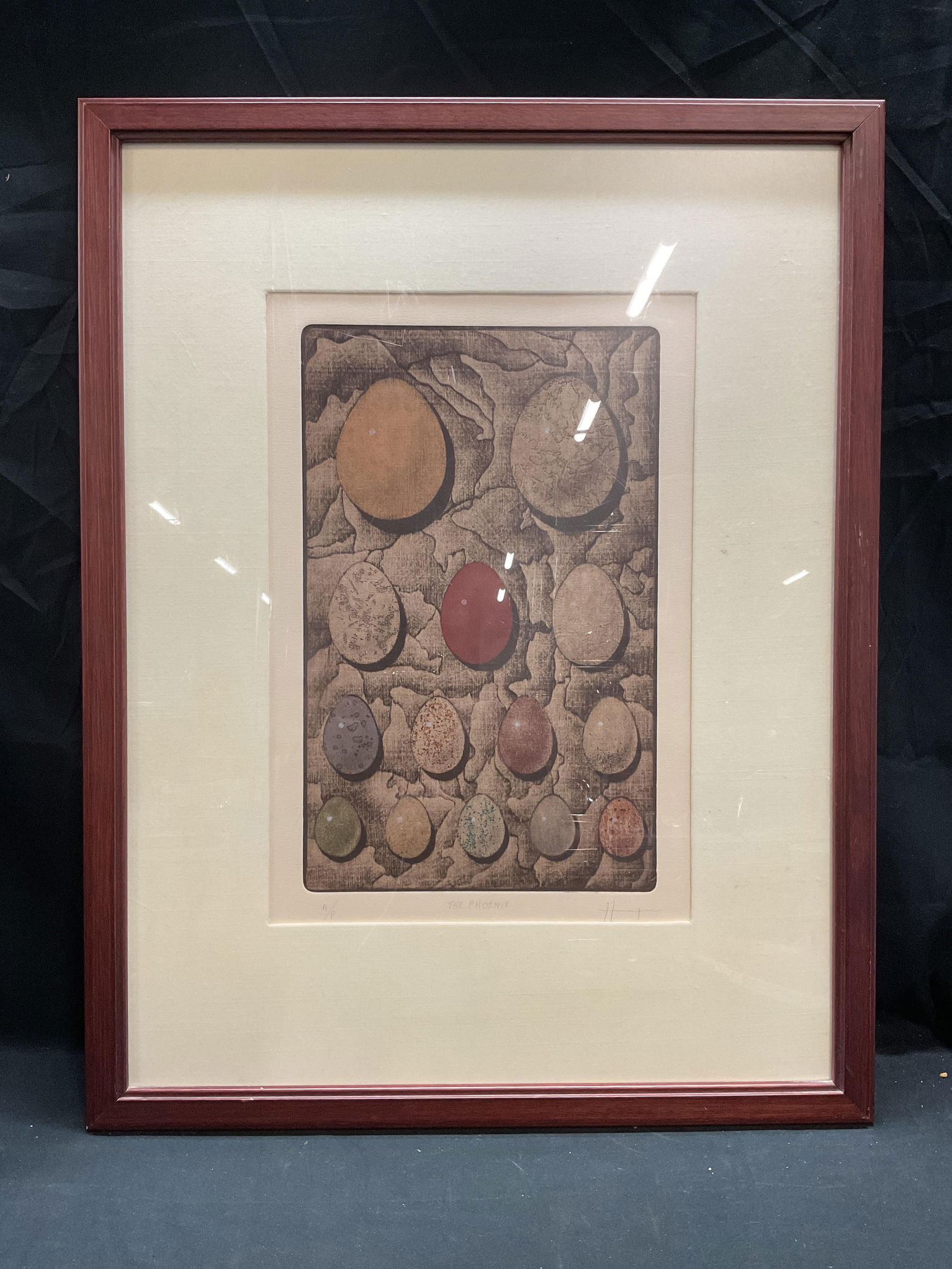 Signed Byron Bratt The Phoenix Mezzotint Print: Framed and matted mezzotint engraving on paper. Signed, titled, and editioned along lower edge in pencil. Byron Bratt, The Phoenix, artist proof. Mezzotint in color. Arrangement of eggs on neutral bac