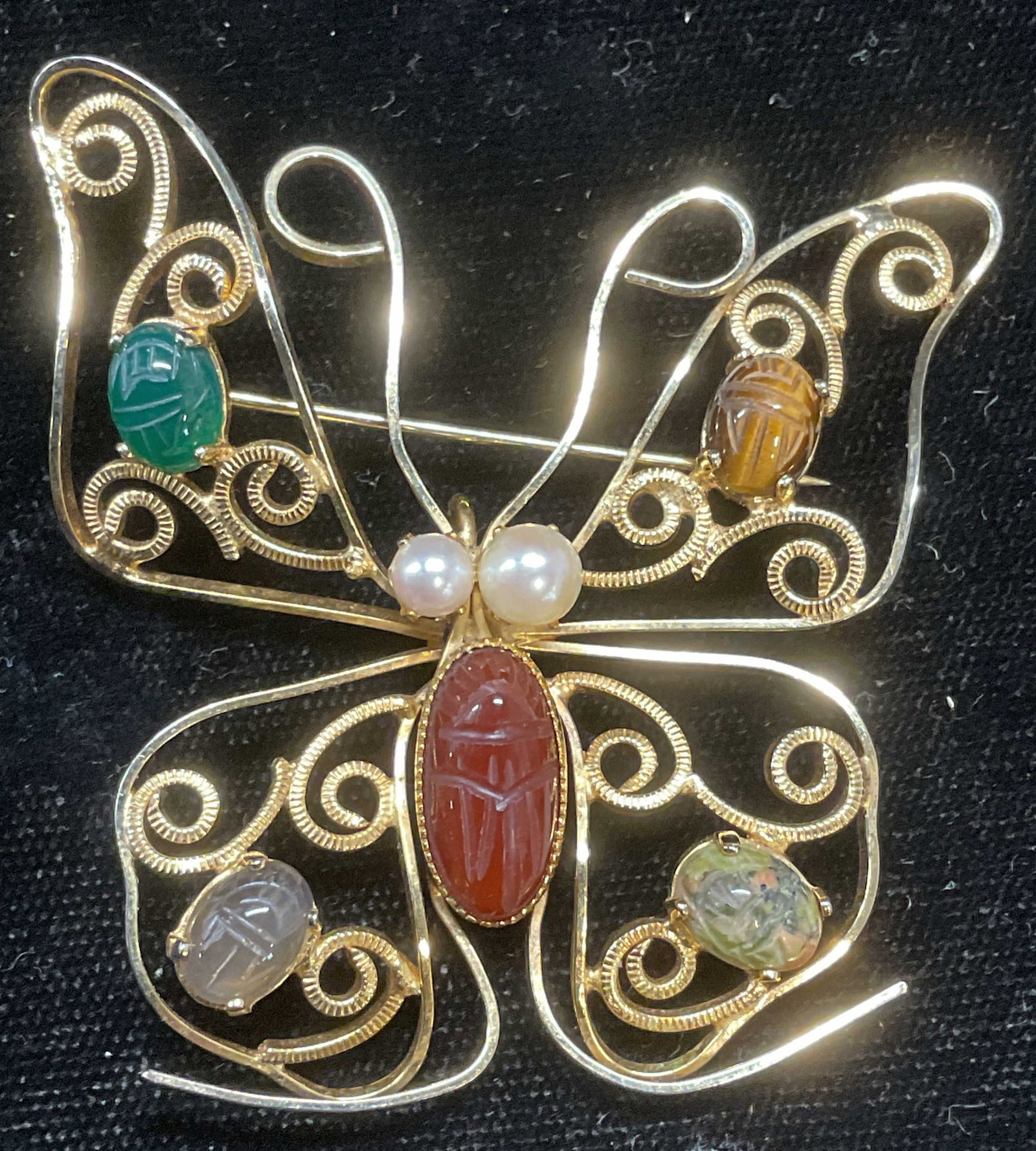 Cassell Gold Filled Semiprecious Butterfly Brooch: Vintage Burt Cassell 12k gold filled butterfly motif wire brooch with multicolor carved scarab semiprecious stones and pearl accents. Signed. Marked 12k Gf. Measures approx 2.25 x 2.25 inches. Some sc