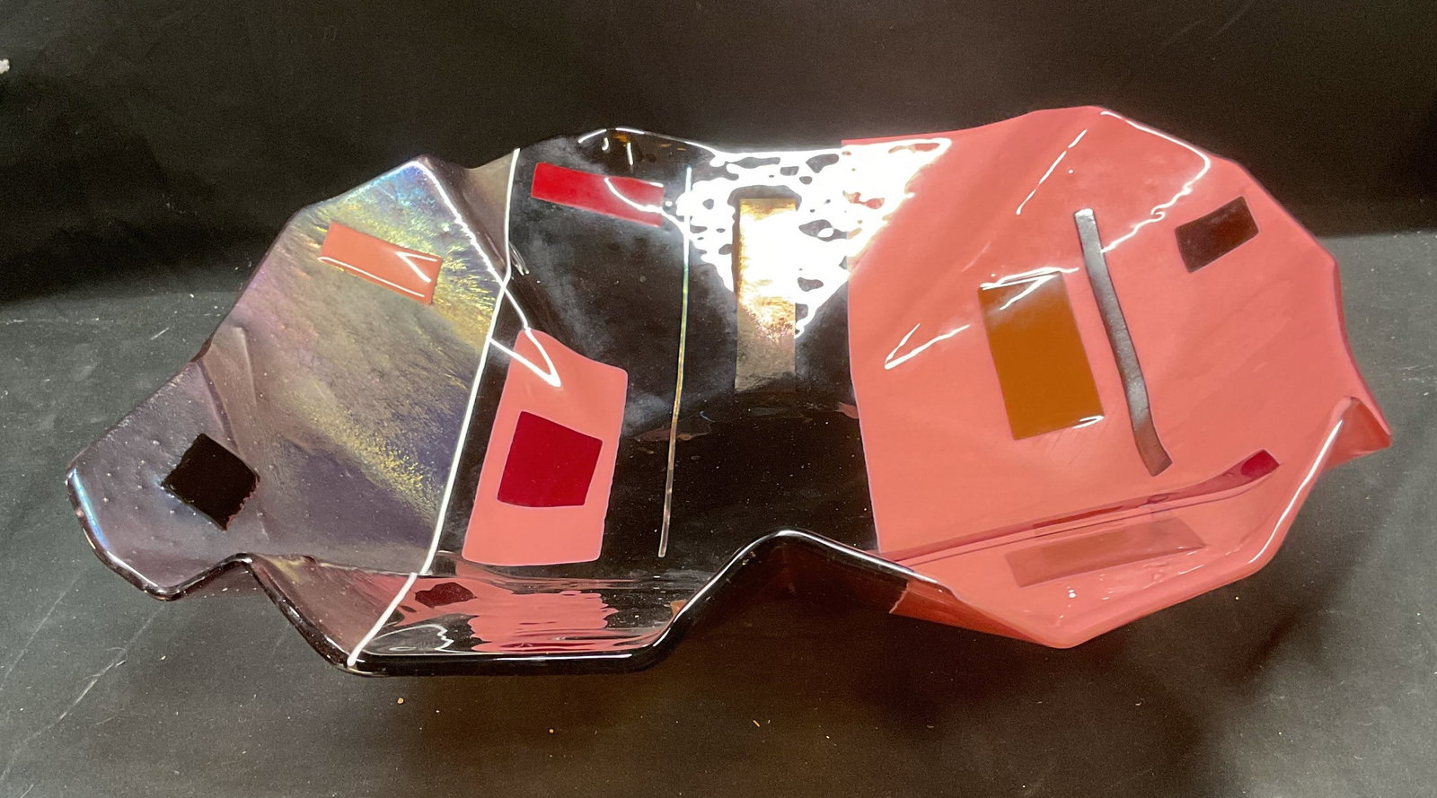 Pink & Brown Art Glass Centerpiece Bowl, 20.5 In: Art glass centerpiece bowl. Fused glass with geometric pattern and handkerchief rim in pink, brown, red and metallic gold. Measures approx 20.5 inches wide, 4 inches deep. Minimal wear consistent with
