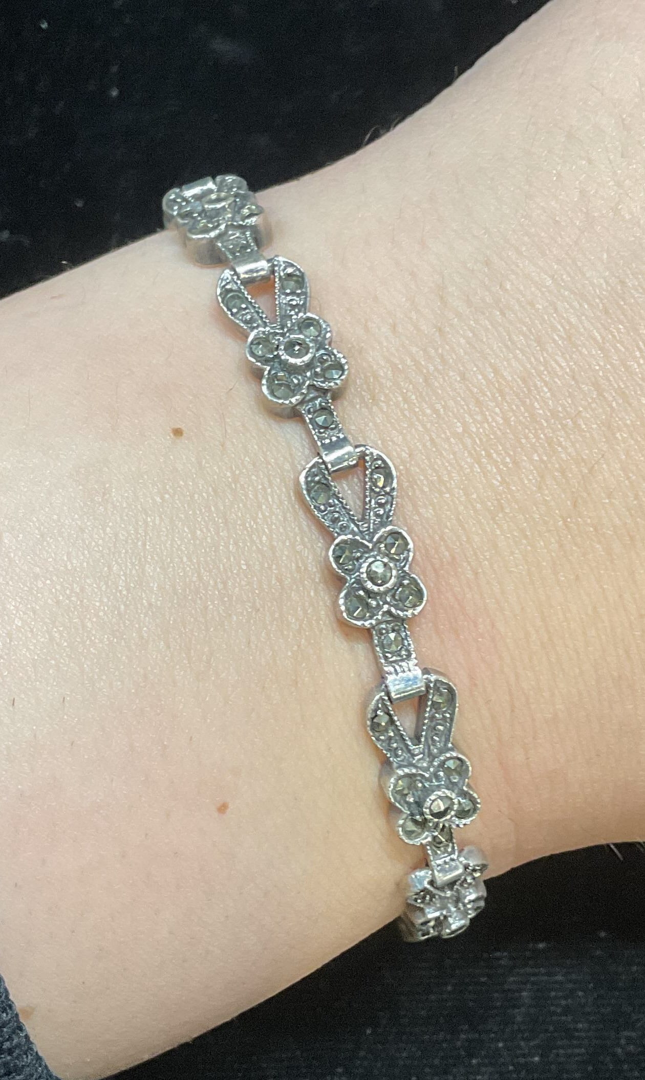 Vintage 825 Silver Marcasite Flower Bracelet: Vintage 825 silver bracelet with flower motif panels link and marcasite decoration. Marked 825. Measures approx 7 inches long. Total weight 17.8 grams. Some wear including scratching. Jewelry, estate