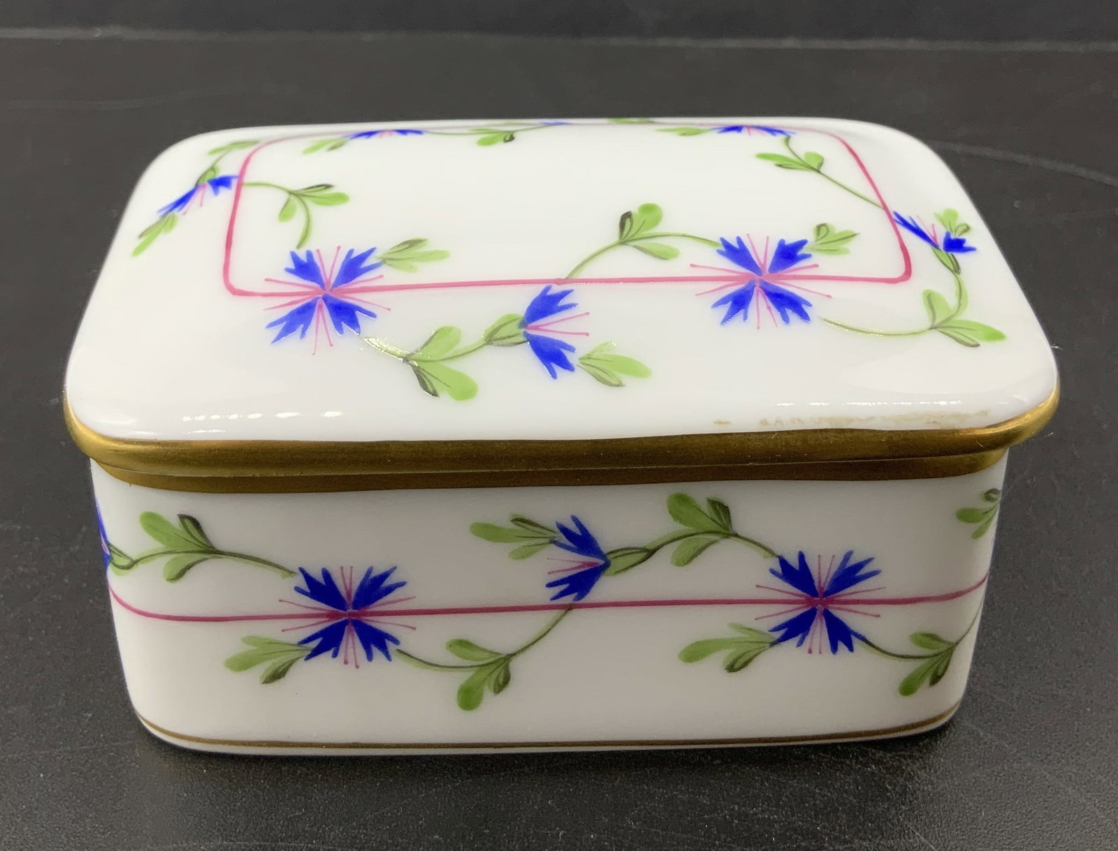 HEREND Blue Garland Porcelain Trinket Box HUNGARY: HEREND Blue Garland Porcelain Trinket Box HUNGARY Porcelain trinket box featuring delicate blue flowers & green vines. Trinket box features a rectangular shape & gold accents. Signed & marked on under