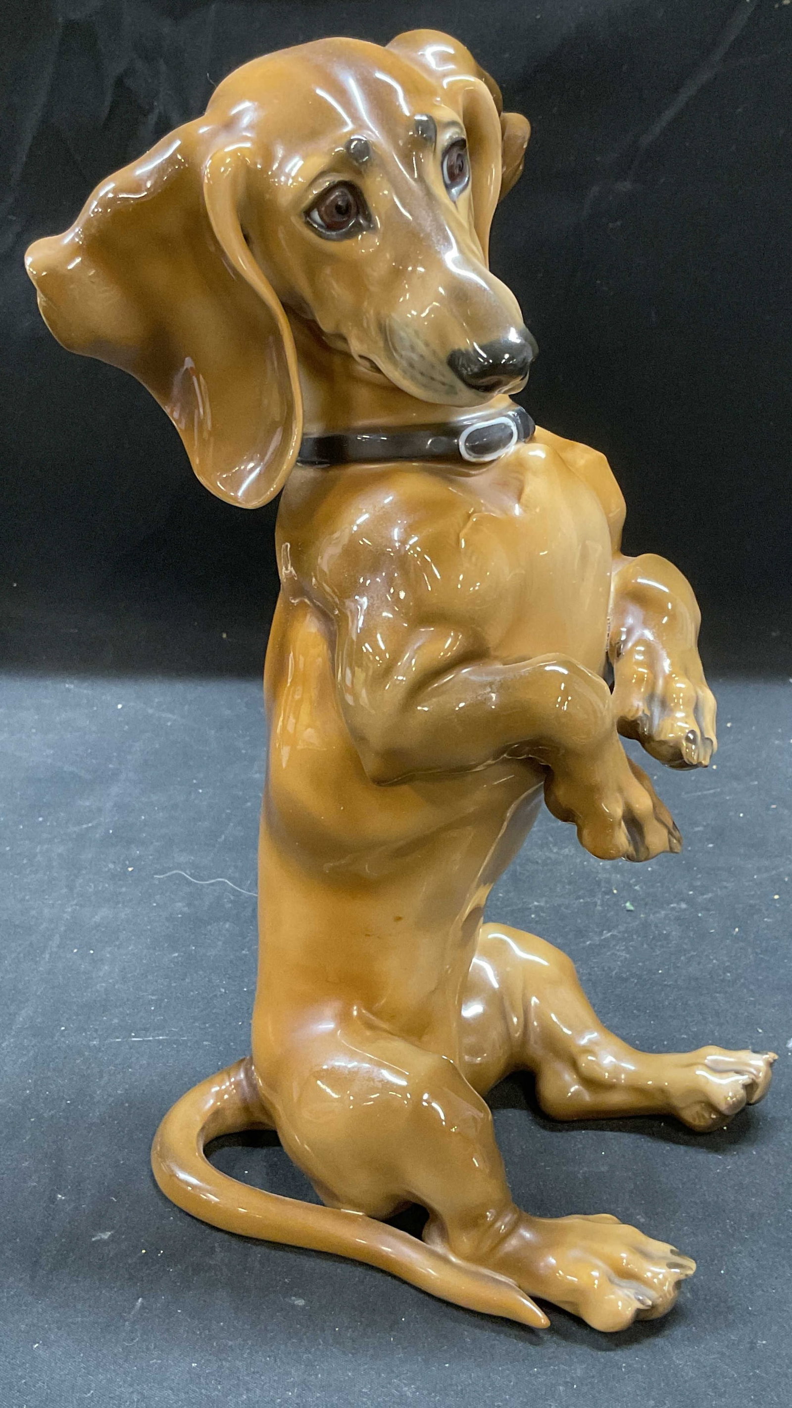 Rosenthal Karner Begging Dachshund Figural Germany: Rosenthal porcelain Begging Dachsund dog figural. Designed by Lrofessor Theodore Karner. Hand painted in brown. Signed. Made in Germany. Measures approx 4.75 x 3.5 x 9.25 inches. Some surface wear con