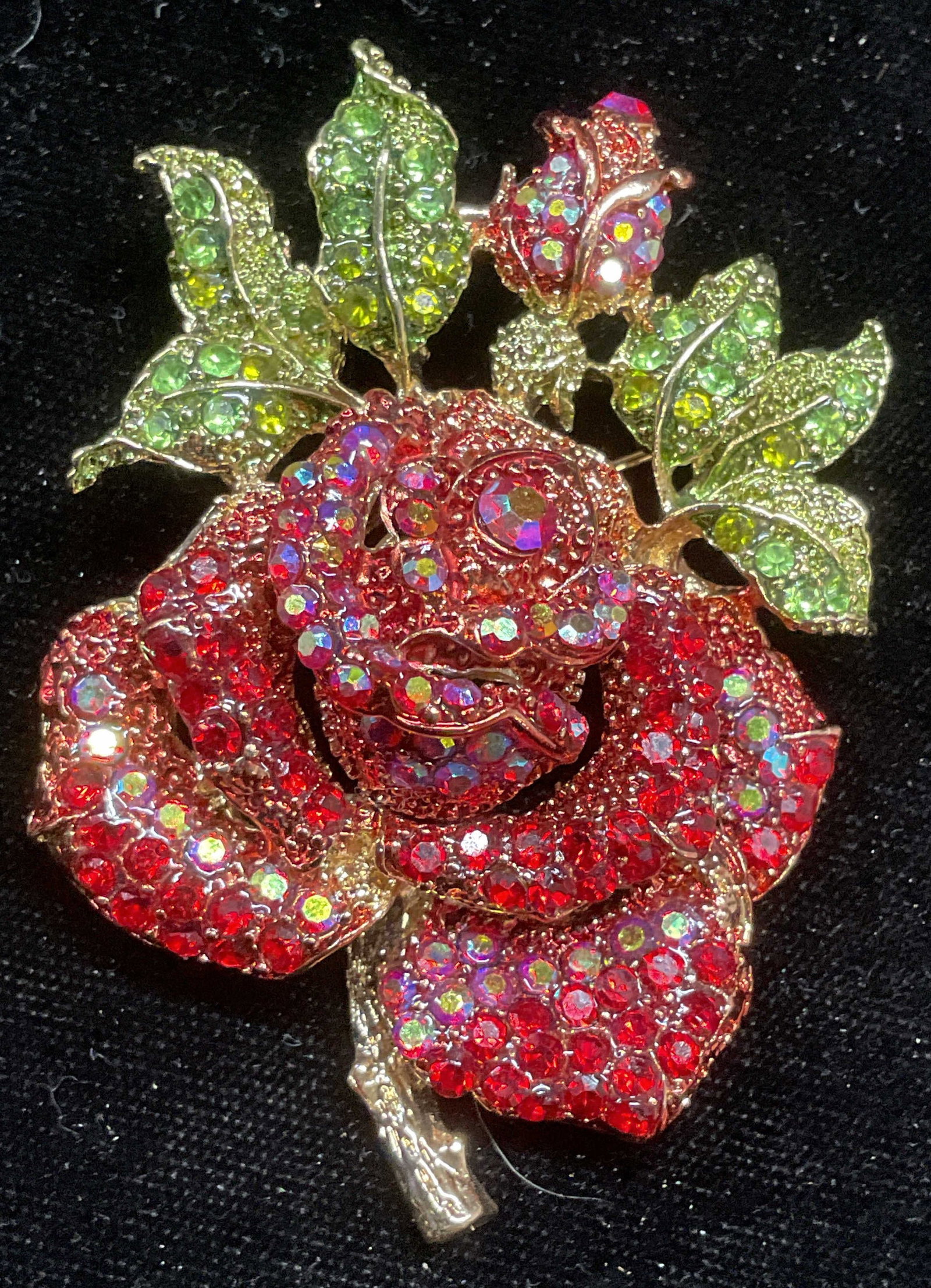 Vtg Gold Tn Red Crystal Rose Flower Brooch: Vintage c. 1950s-60s gold tone rose flower motif brooch with red and green crystals. Measures approx 2.75 x 2 inches. Some wear including scratching. Jewelry, estate jewelry costume jewelry, cocktail 