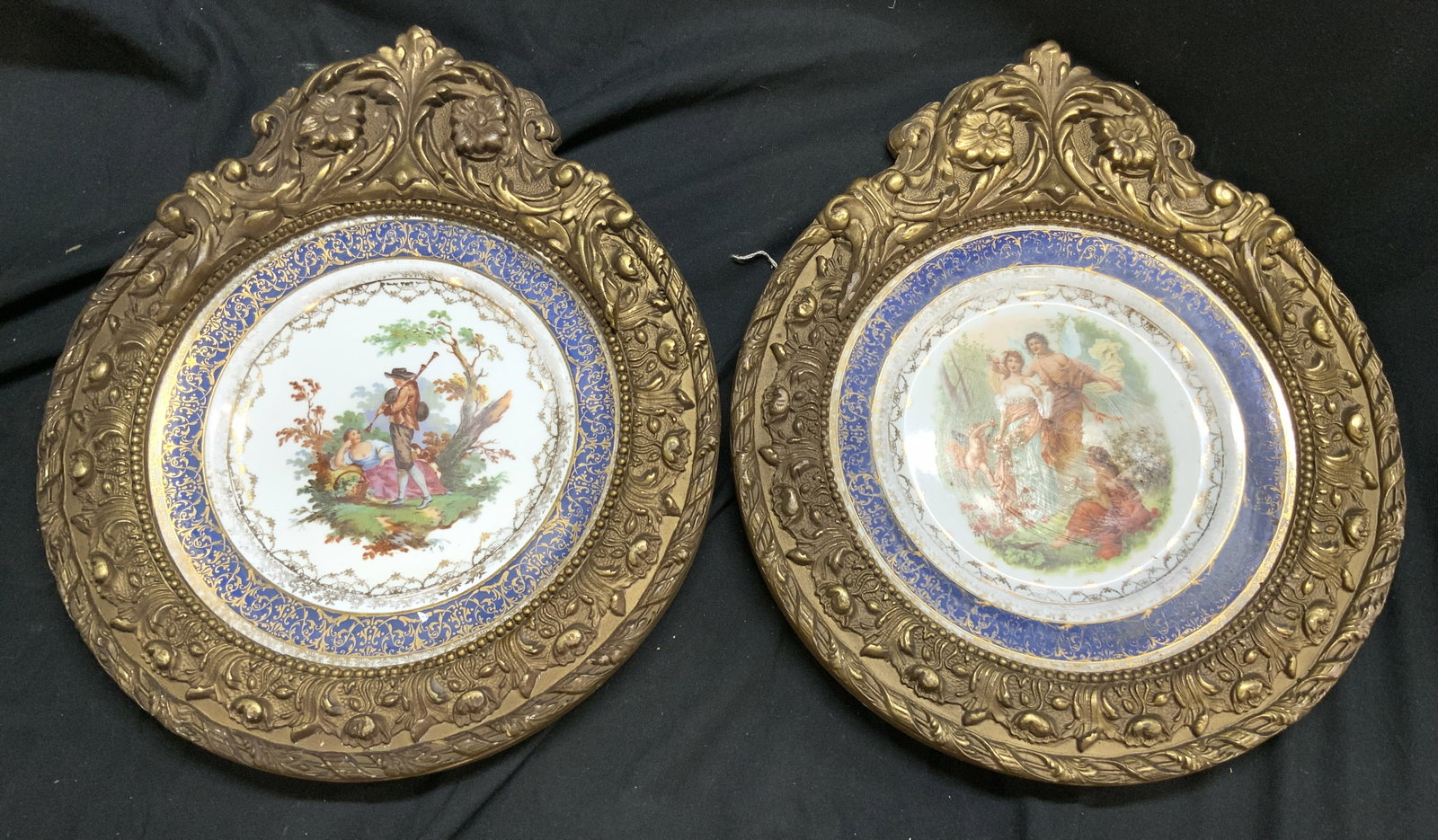 OP CO EDGEWOOD China Prc Plts W Ornate Gilt Frames: Undersides of plates are marked OP CO SURACUSE EDGEWOOD CHINA. Lot includes 2 plates. One depicts and angel, cherub and female figures, one depicts a male figure playing an instrument next to a female