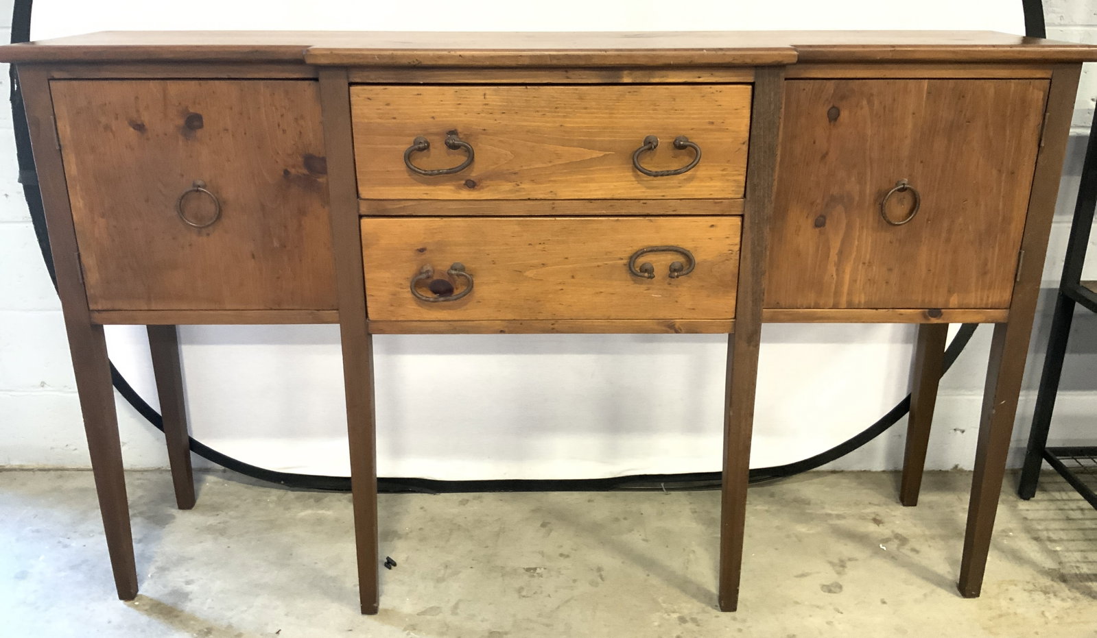 Vtg American Wood Sideboard W Drawers & Cabinets: Sideboard is vintage. Piece is tan toned and wooden. Sideboard has 2 drawers and 2 cabinets. Piece has gilt metal handles. Sideboard measures approximately 66 inches long 40 inches tall 14 inches deep