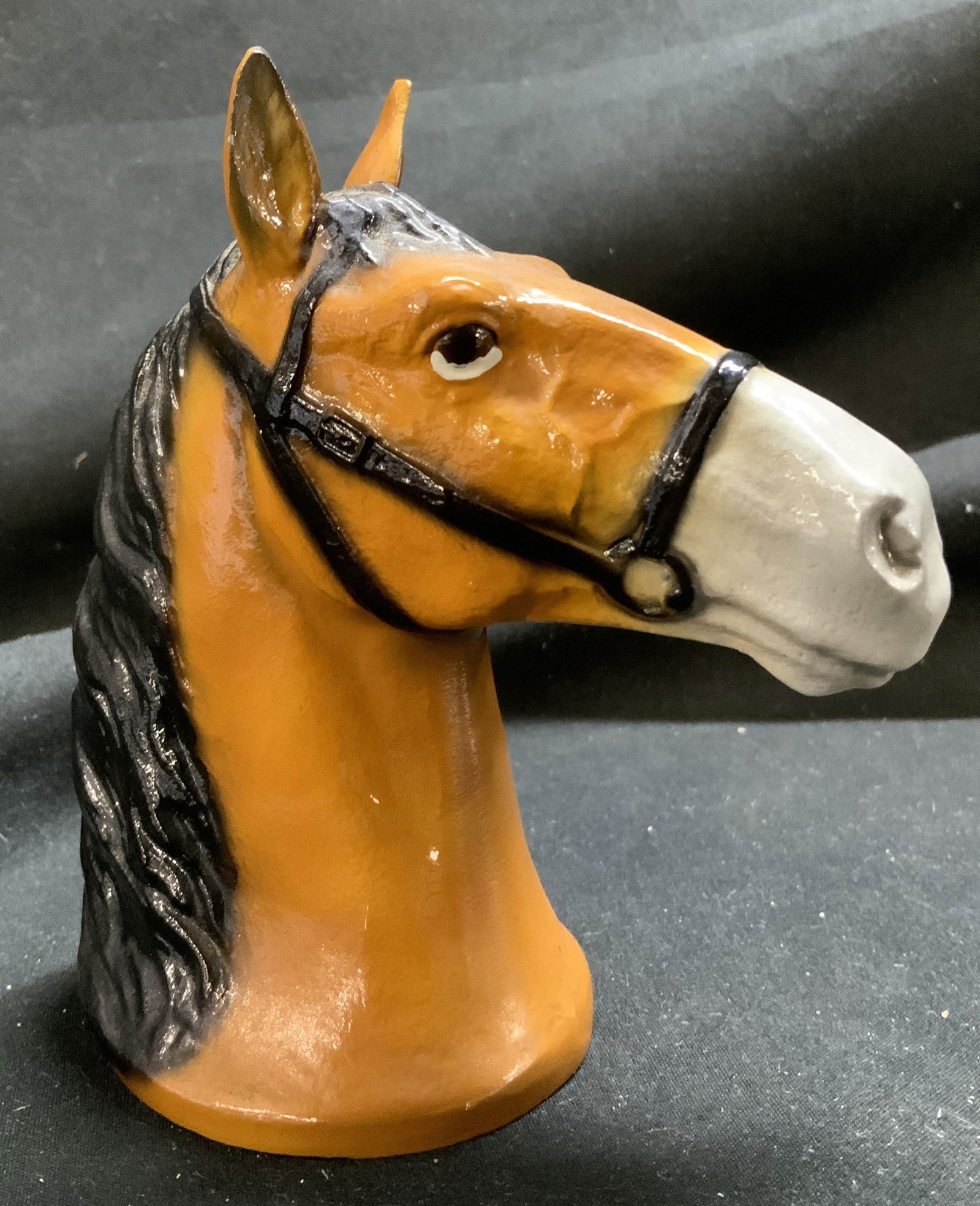 Vintage Cast Iron Horse Head Figurine: Vintage Cast Iron Horse Head Figurine Figurine is made of cast iron material & features a horse head design with a brown body & a black muzzle. Appears to be possible bottle opener. Surface wear consi