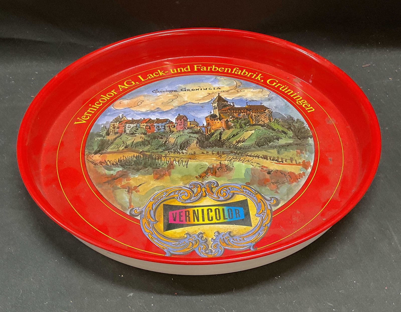 Vernicolor AG Swiss Scene Enamel Serving Tray 12in: Vernicolor AG promotional advertising enamel metal serving tray, Swiss town scenery. Measures approx 12 x 1.25 inches. Some wear including scratching. Vernicolor ag tray, serving tray, enamel tray, pr