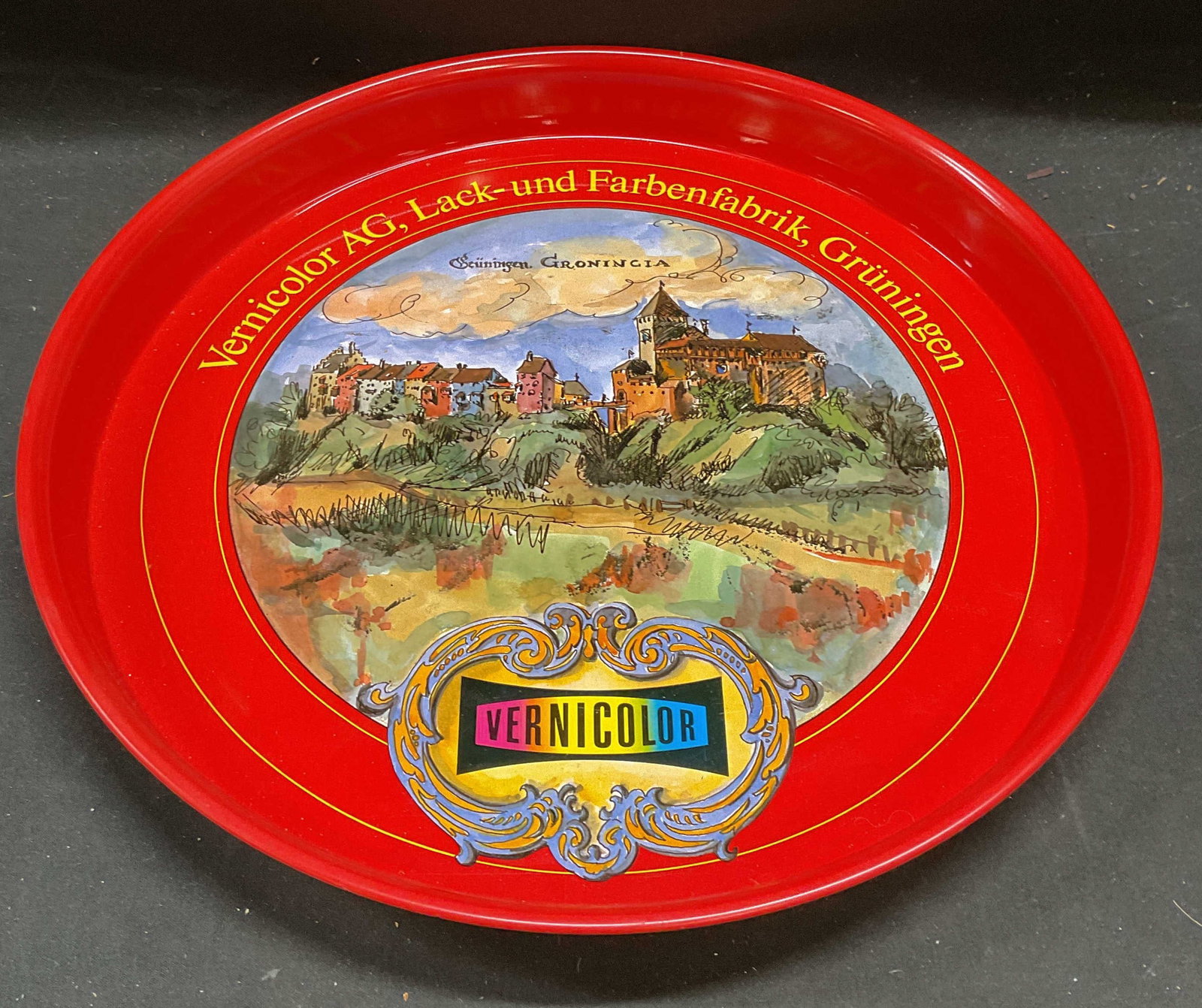 Vernicolor AG Swiss Scene Enamel Serving Tray 12in: Vernicolor AG promotional advertising enamel metal serving tray, Swiss town scenery. Measures approx 12 x 1.25 inches. Some wear including scratching. Vernicolor ag tray, serving tray, enamel tray, pr