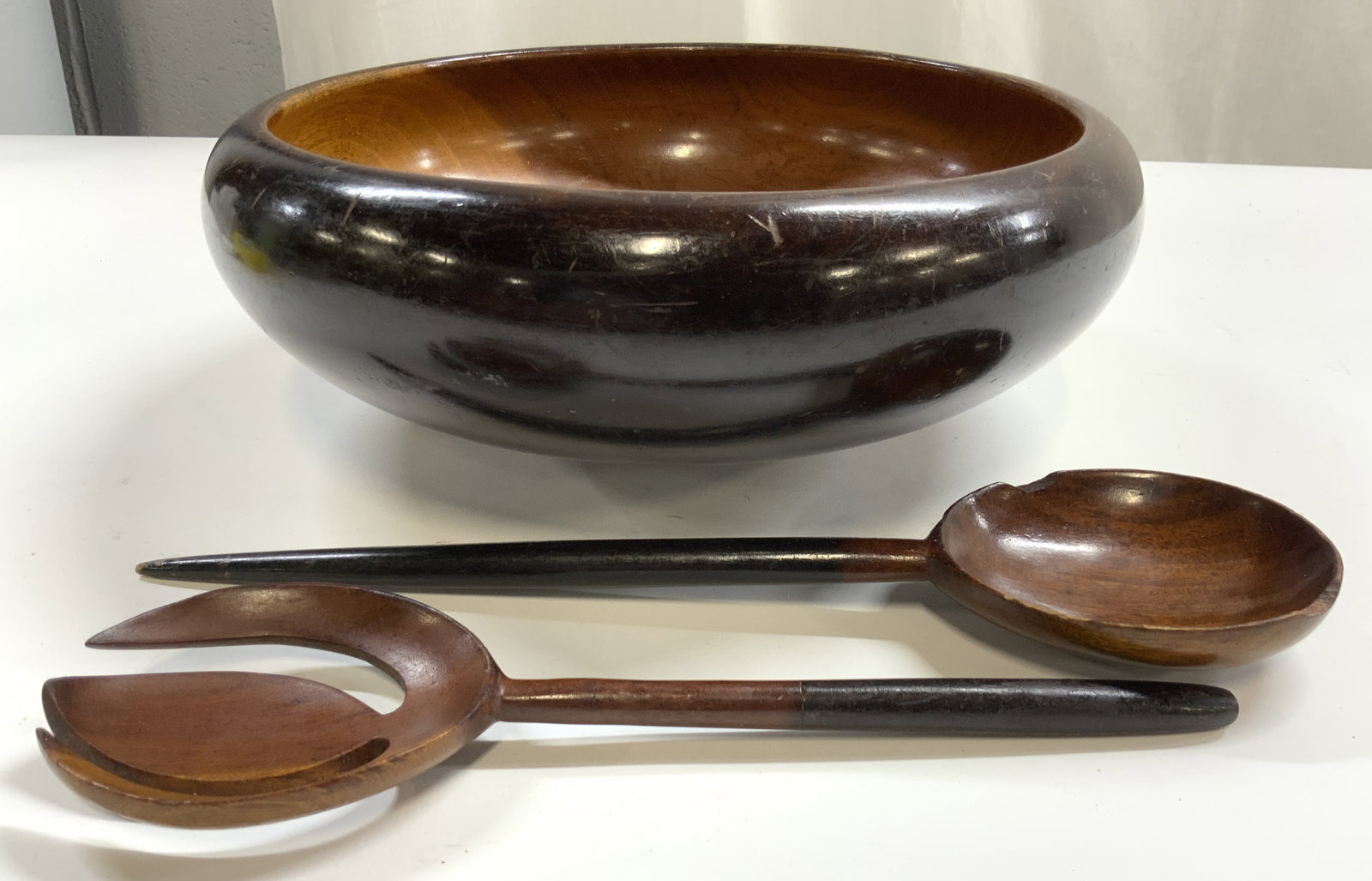 Lot 3 Teakwood Bowl & Salad Serving Utensils: Lot includes 1 bowl, 1 salad serving spoon, & 1 salad serving fork. Each piece is brown toned and wooden. Possibly teakwood. Bowl measures approximately 11.5 inches wide 4.25 inches tall. Salad servin