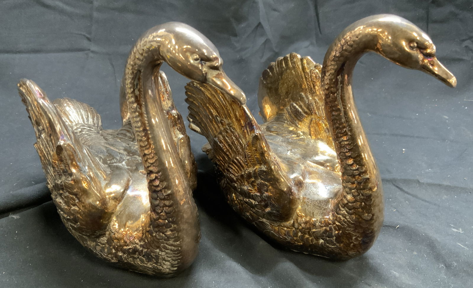 Vintage Pair Gilt Metal Swan Figures: Lot includes 2 Swan figures. Each are gilt metal (copper & silver toned finishes). Each have relief to show detailing in feathers. Each appear to be vintage. Undersides are lined with red toned felt.