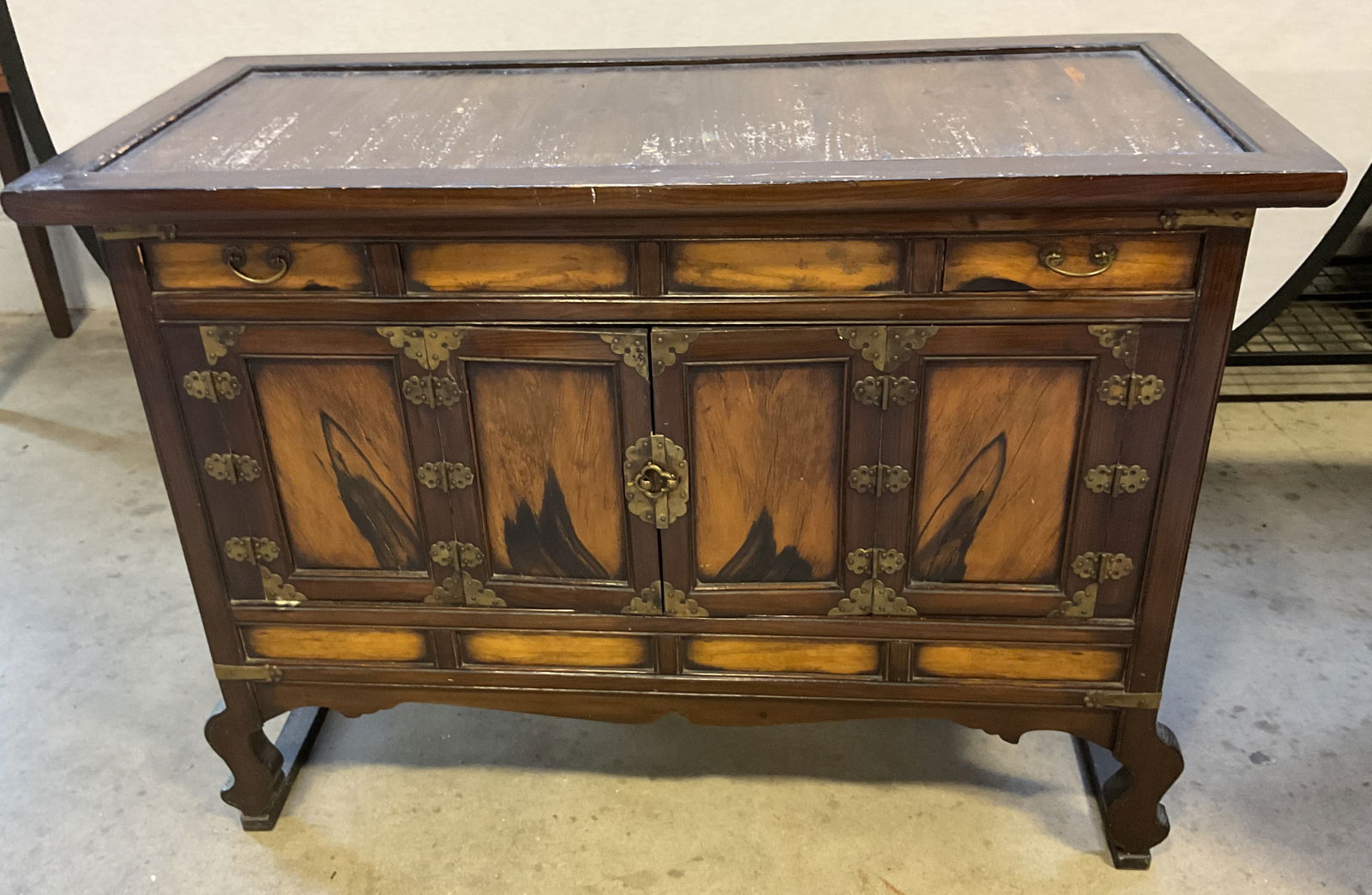 Vintage Wood & Brass Side Cabinet: Vintage wood side cabinet. Dark finished wood with brass hardware, handles, and corner plates. 2 drawers with lower cabinet. Measures approx 39.25 x 18.25 x 28.25 inches. Surface wear including scratc