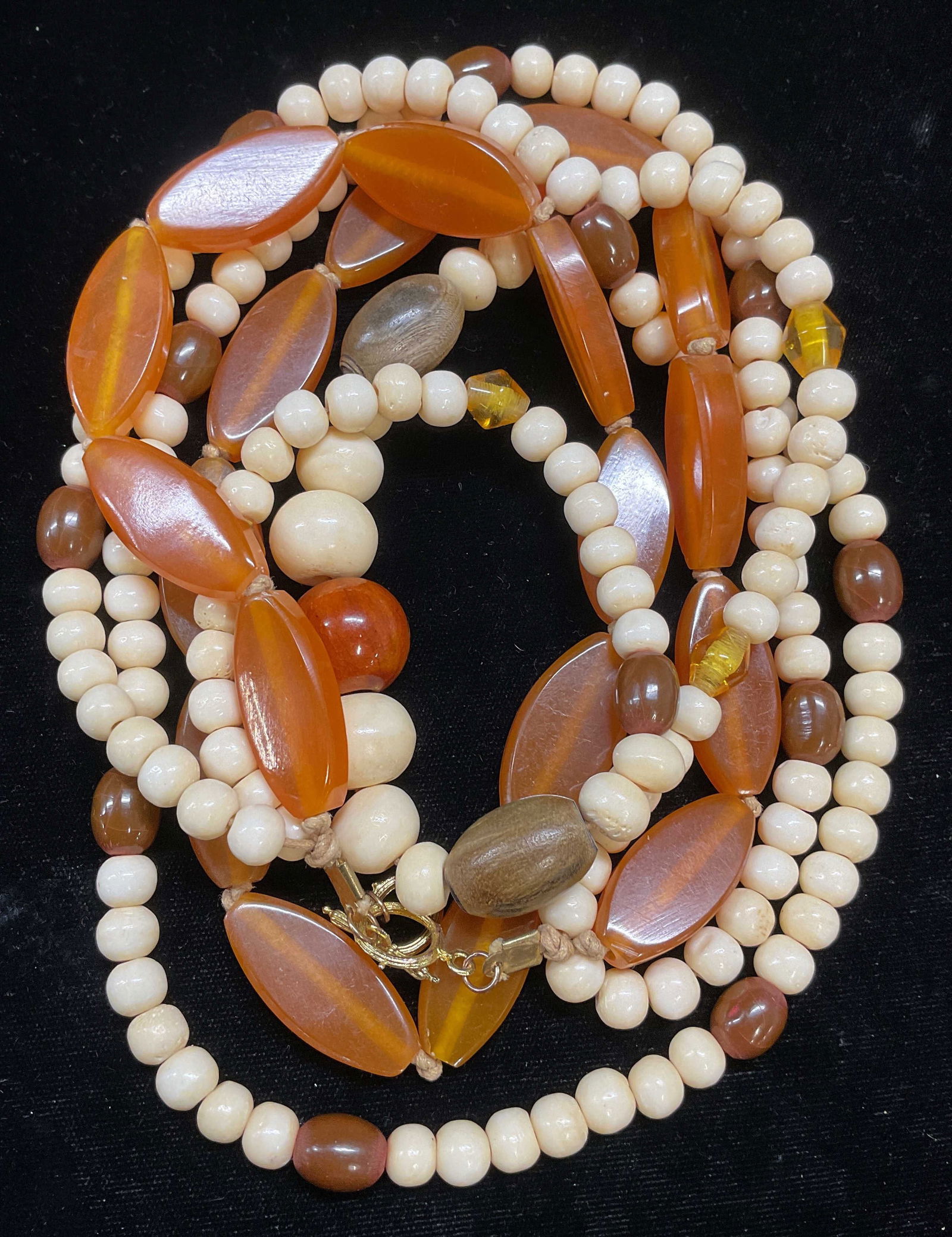 Vintage Amber Wood Bone Beaded Necklace: Vintage beaded multi strand necklace with bone and wood. Possibly Amber beads, possibly costume. Drop length approx 16 inches. Some scratching. Jewelry, estate jewelry, cocktail jewelry, fashion jewel