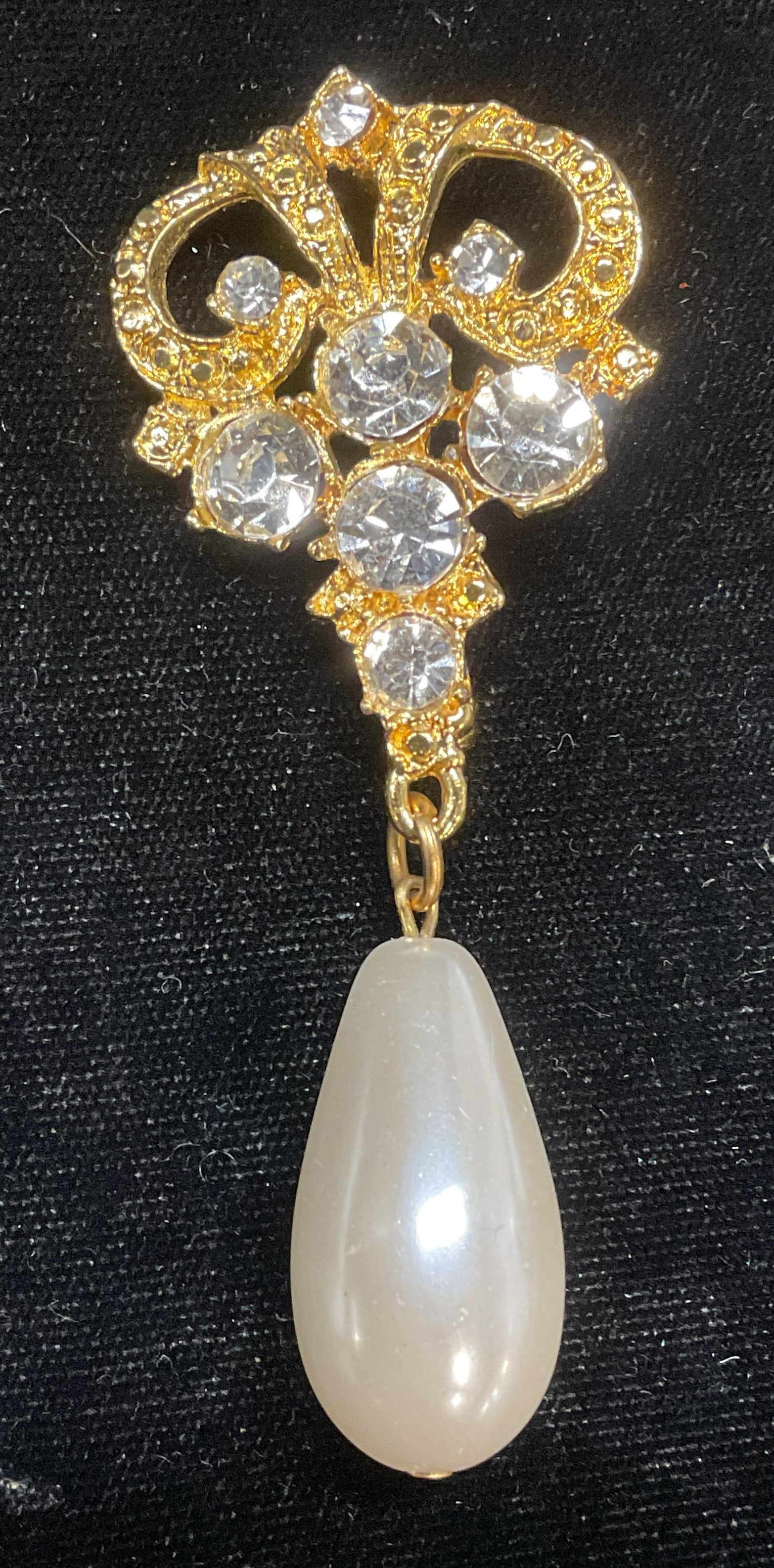 Gold Tone Crystal Faux Pearl Pendant Brooch: Gold tone scroll motif brooch with colorless crystal decoration and faux pearl pendant. Measures approx 3.25 x 1.25 inches. Some scratches observed. Jewelry, estate jewelry, costume jewelry, cocktail 
