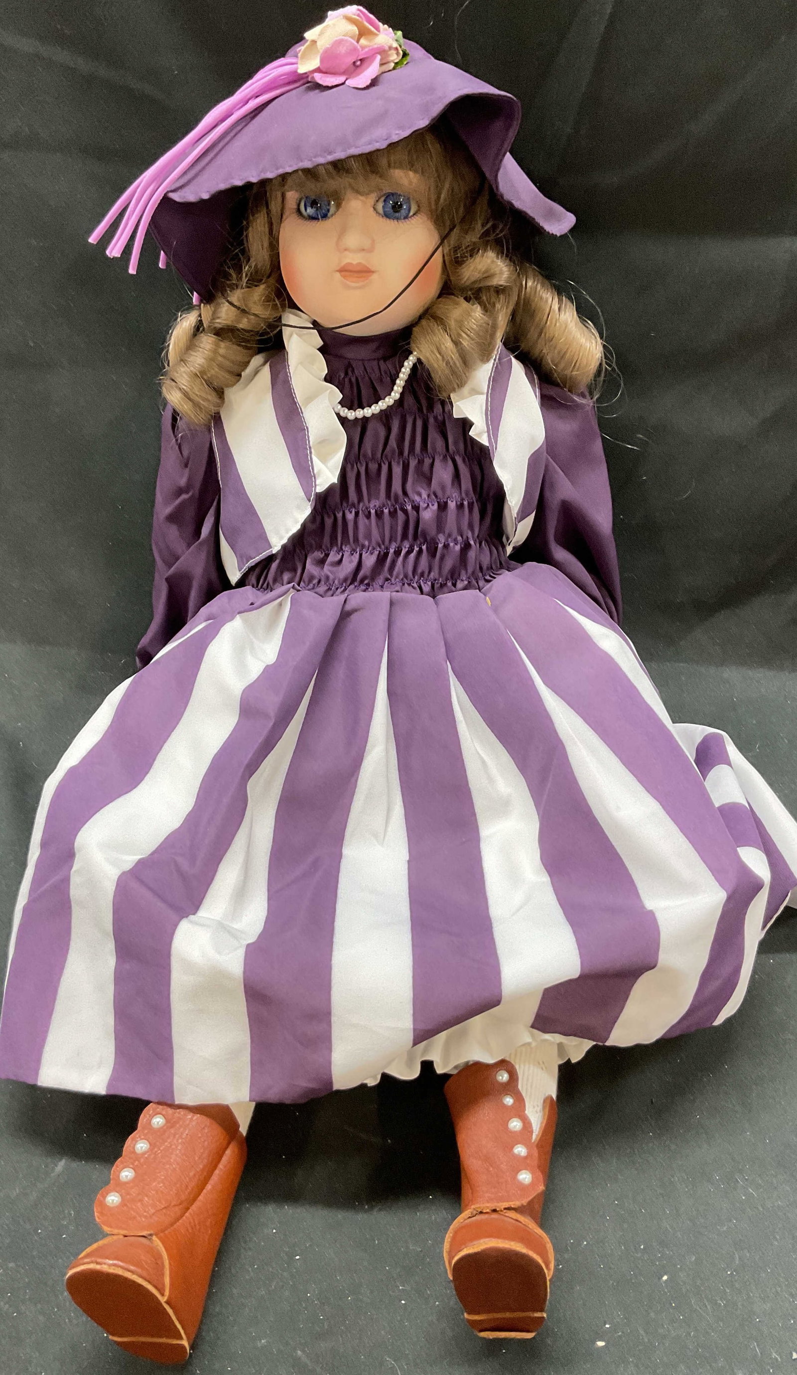 Vtg 21in Purple Dress Curled Hair Hat Doll: Vintage 21in purple dress curled hair hat doll. Brunette doll with blue eyes. Includes removable jacket, hat. Pearl necklace. Purple and white striped dress. Includes shoes. Measures approximately 21 