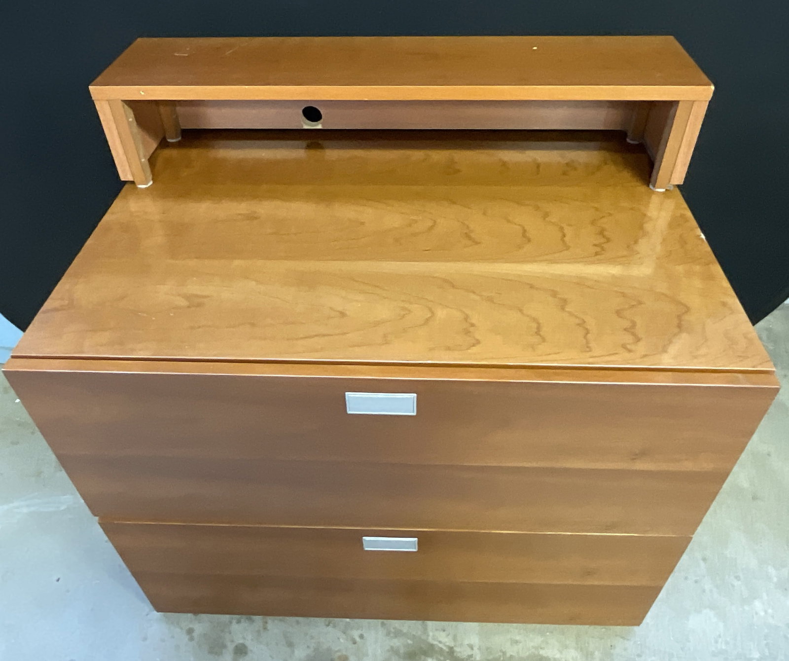 Two Drawer Dresser / Chest: Two Drawer Dresser / Chest. Comes with a removable top piece. Crafted from wood and veneer. Silver tone drawer pulls to the obverse. Measures approx. 24D x 35W x 25H in. Measurement does not include r