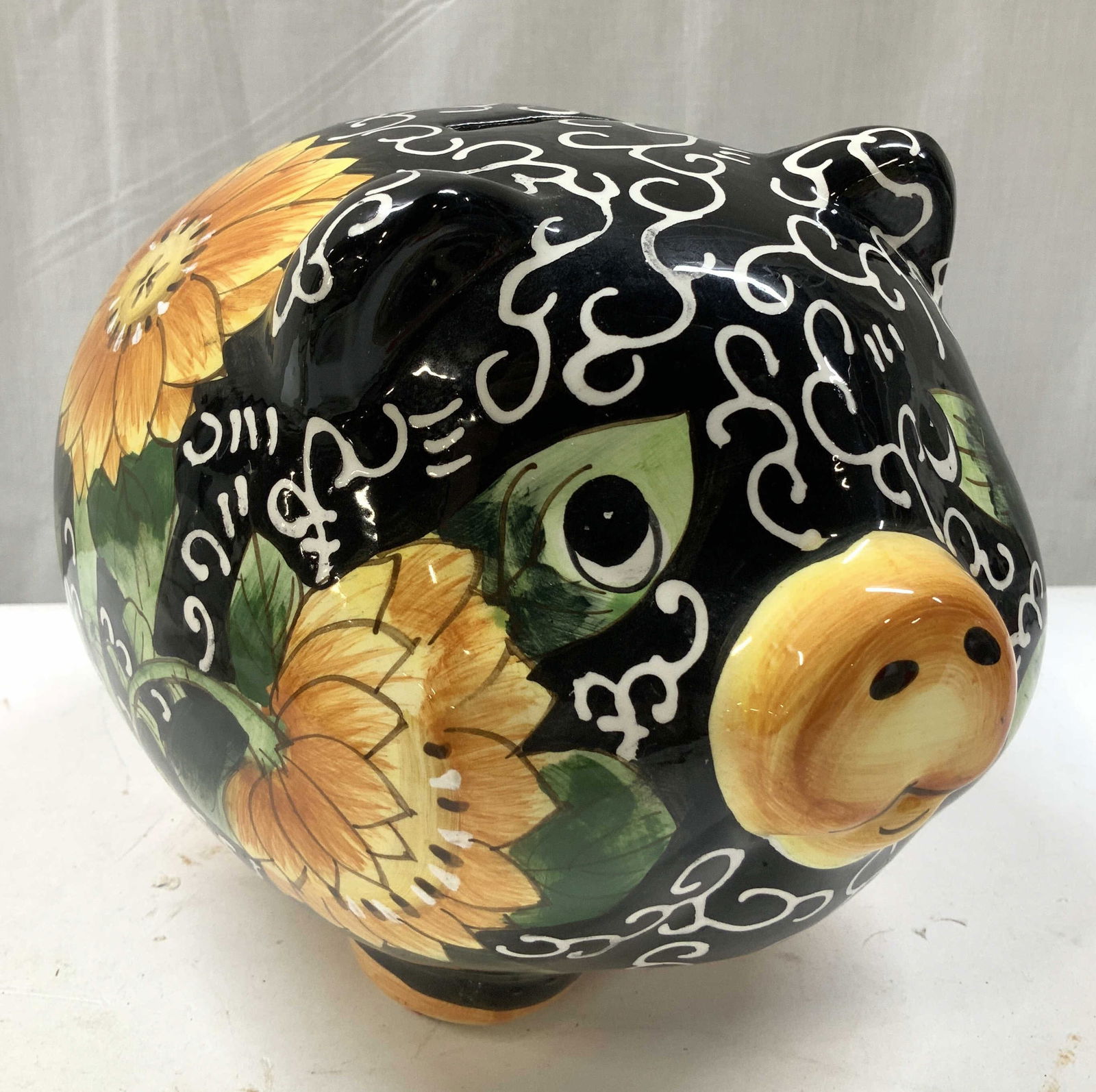 Vntg Hand Painted Sunflower Ceramic Piggy Bank: Vntg Hand Painted Sunflower Ceramic Piggy Bank Ceramic piggy bank/coin bank featuring hand-painted floral designs, specifically sunflowers. Surface wear consistent to age, use & exposure. Measurements