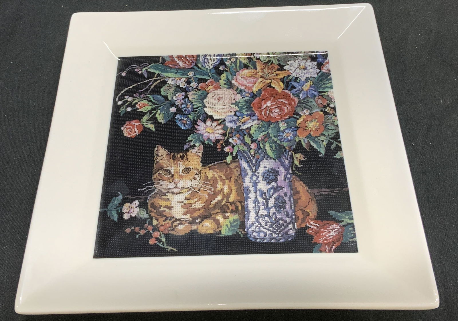 Vntg 1989 HALLMARK K Kuntscher Cat Plate JAPAN: Vntg 1989 HALLMARK Cat W Bouquet Plate JAPAN Vintage 1989 Hallmark plate depicting an orange tabby cat next to a vase of flowers. Image resembles a cross-stitch design & is ceramic material. Signed &