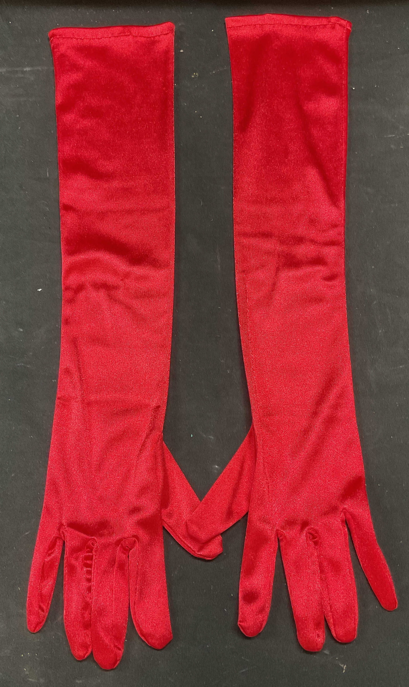 Red Satin Stretch Long Opera Gloves: Red long opera gloves. Stretch satin. Synthetic material. Measure approx 20.5 inches long. Some wear to material consistent with exposure. Gloves, ladies gloves, red gloves, satin gloves, long gloves,