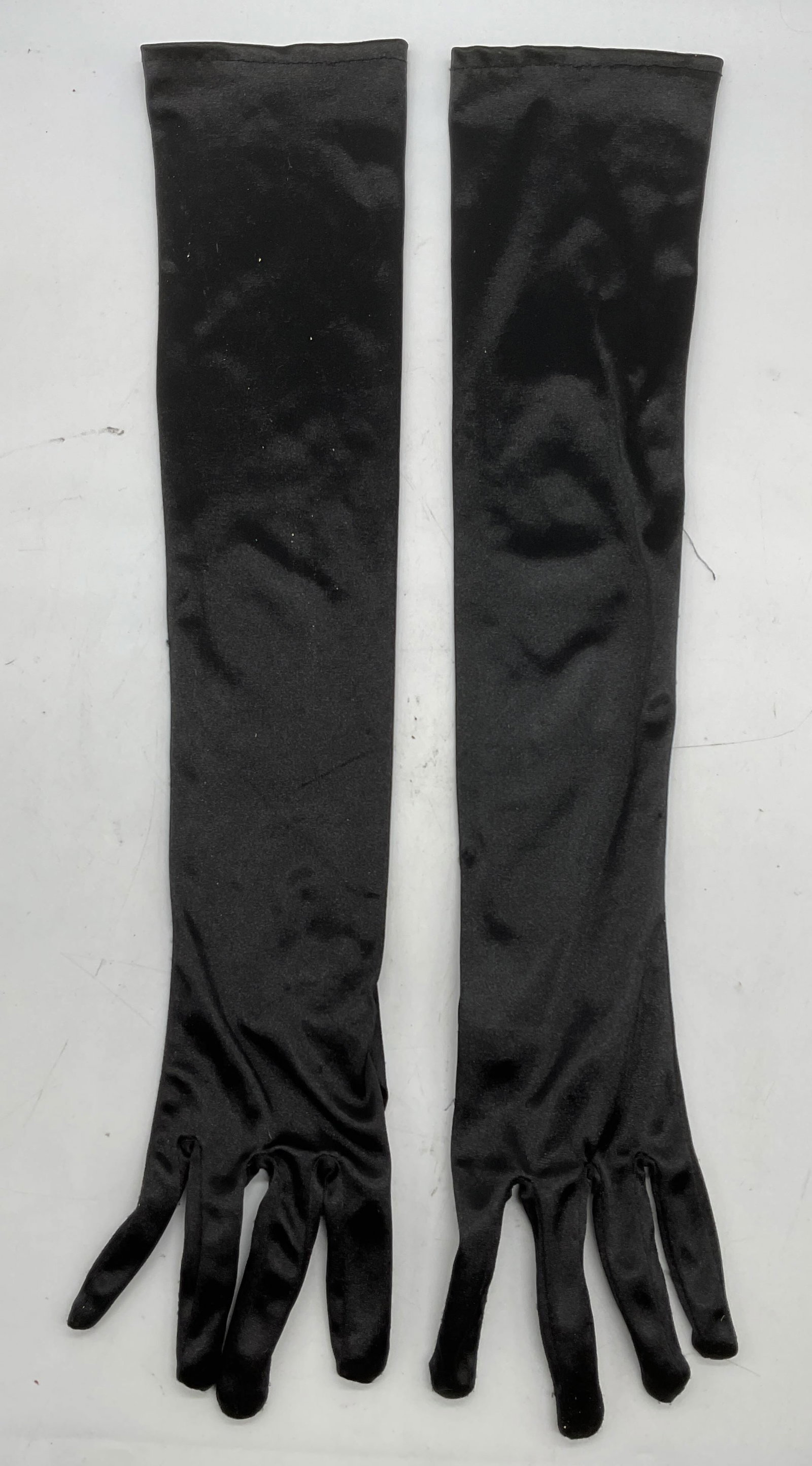 Black Long Satin Stretch Opera Gloves: Black long opera gloves. Stretch satin. Synthetic material. Measure approx 21 inches long. Some wear to material consistent with exposure. Gloves, ladies gloves, black gloves, satin gloves, long glove