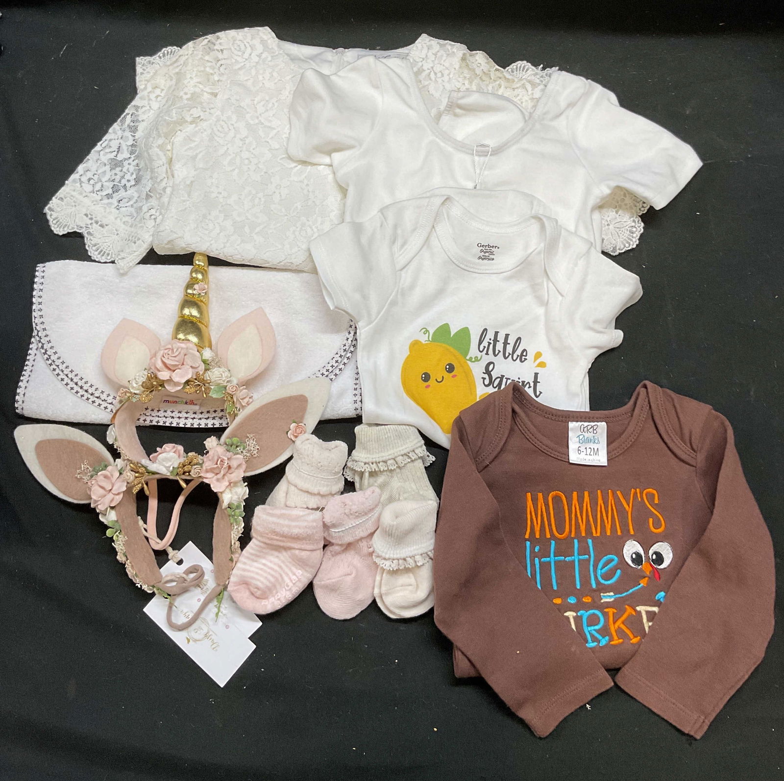 Lot 12 Baby Clothes & Accessories, GAP, Gerber +: Lot of 12 pieces. 5 pairs of baby socks in pink and beige, one pair labeled GAP size 3-6 months. Gerber Little Squirt lemon onesie, size 12 months. ARB Blanks embroidered Mommys Little Turkey Thanksgi