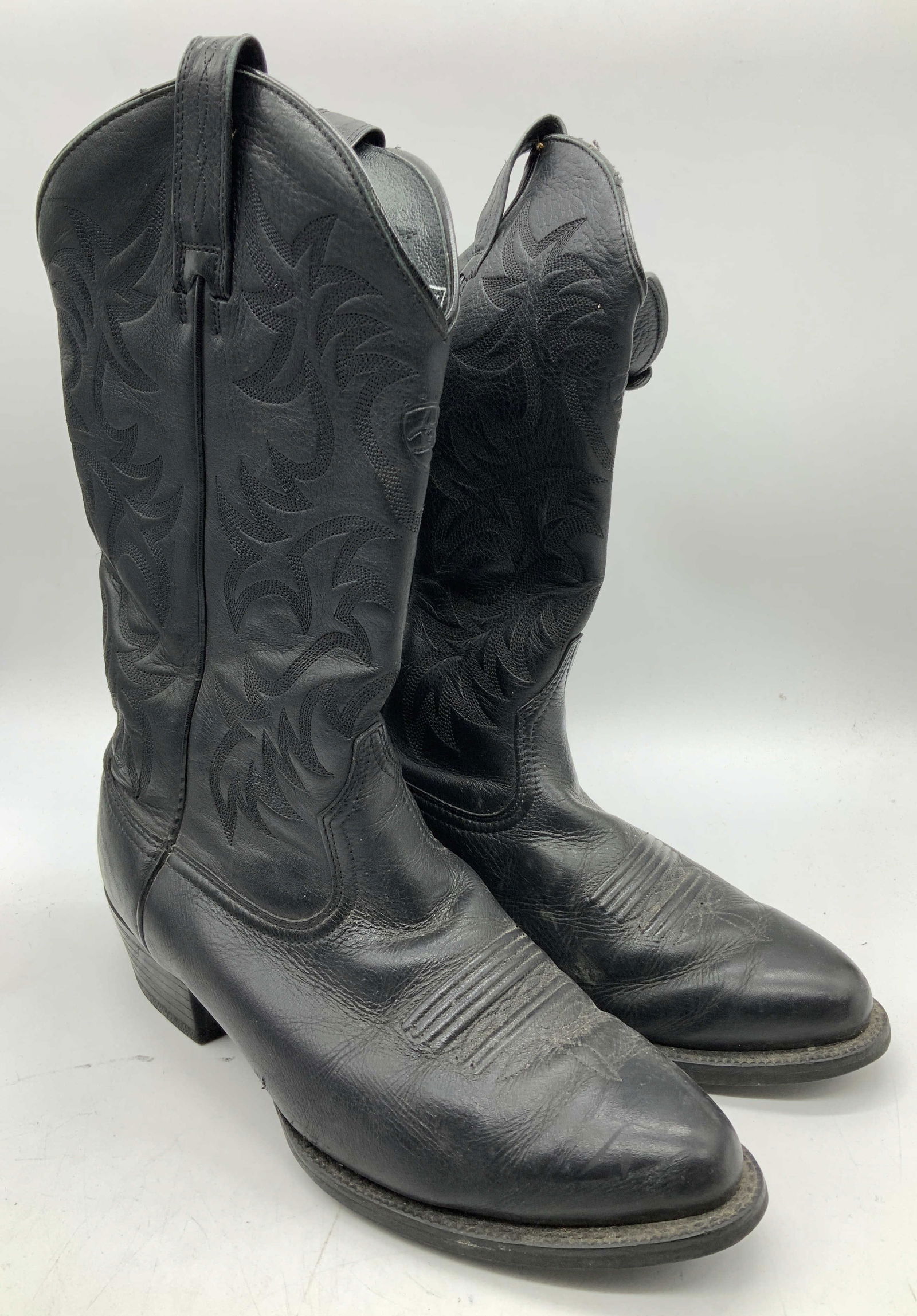 Ariat International Heritage Western Leather Boots: Ariat International Heritage Western Leather Boots Western leather boots featuring intricate embossed/tonal stitching on upper half of boot. Boot has a stacked heel. Signed & marked. Reads, ENGINEERED