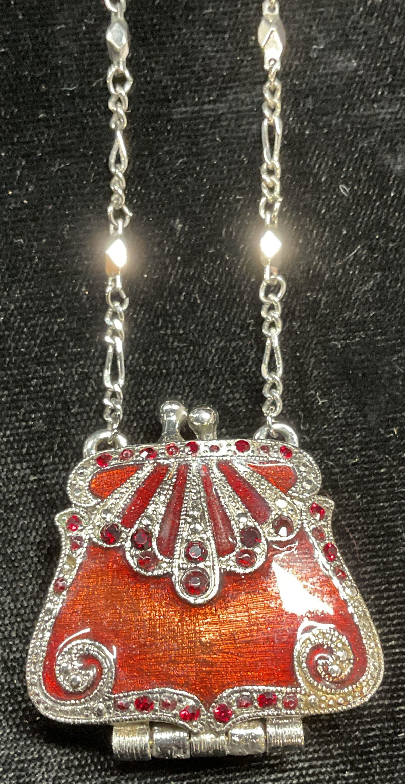 VCLM Silver Tn Enamel Purse Necklace: Signed VCLM silver tone pendant necklace. Red enamel and crystal, purse motif locket pendant. Drop length approx 11.5 inches. Some scratching observed. Locket clasp needs repair. Jewelry, estate jewel