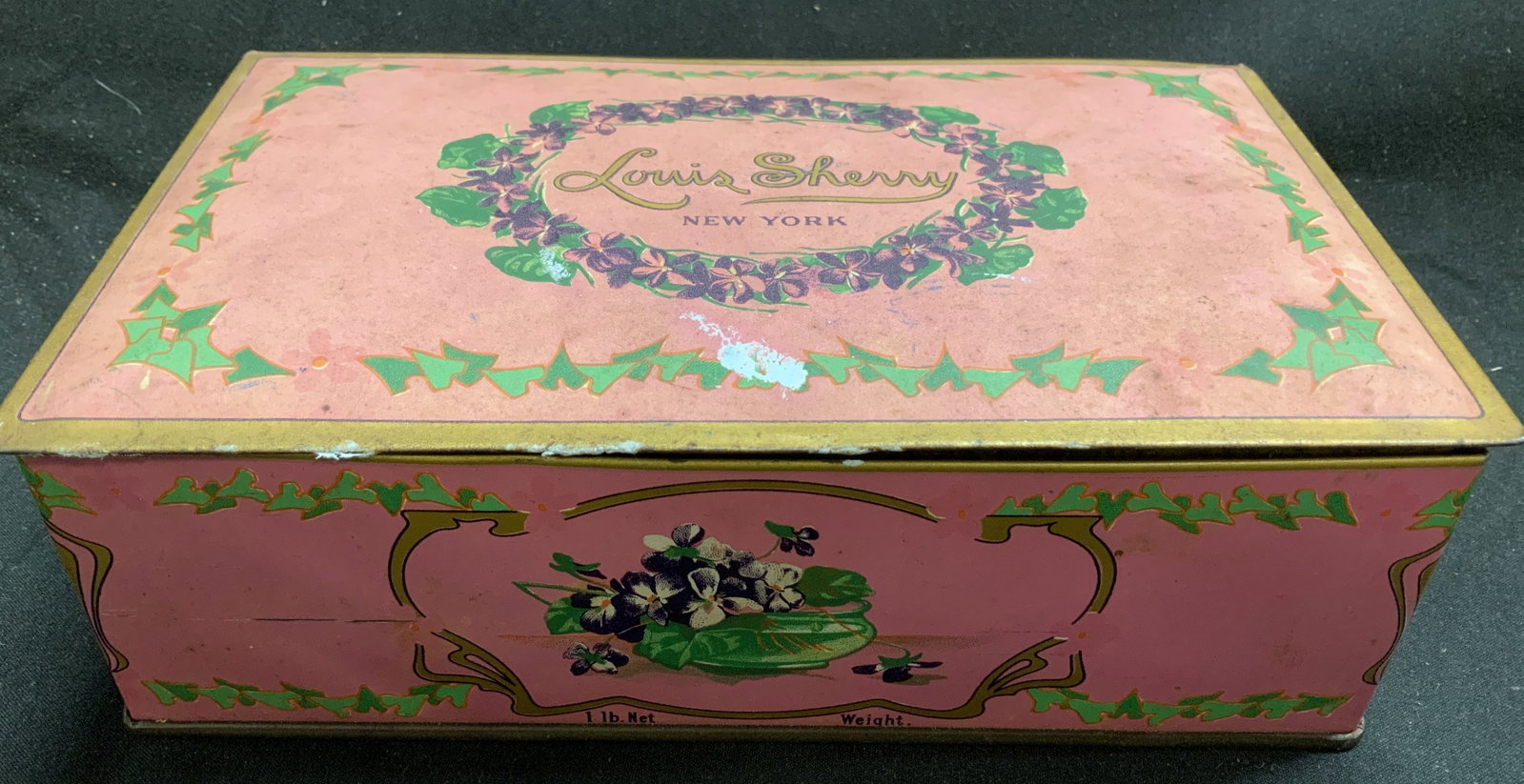 Vntg Louis Sherry NY Violet Candy Tin Box: Vntg Louis Sherry NY Violet Candy Tin Box Louis Sherry is a confectionery brand established in New York in 1881, known for its chocolates and confections. Tin box is adorned with a floral violet desig