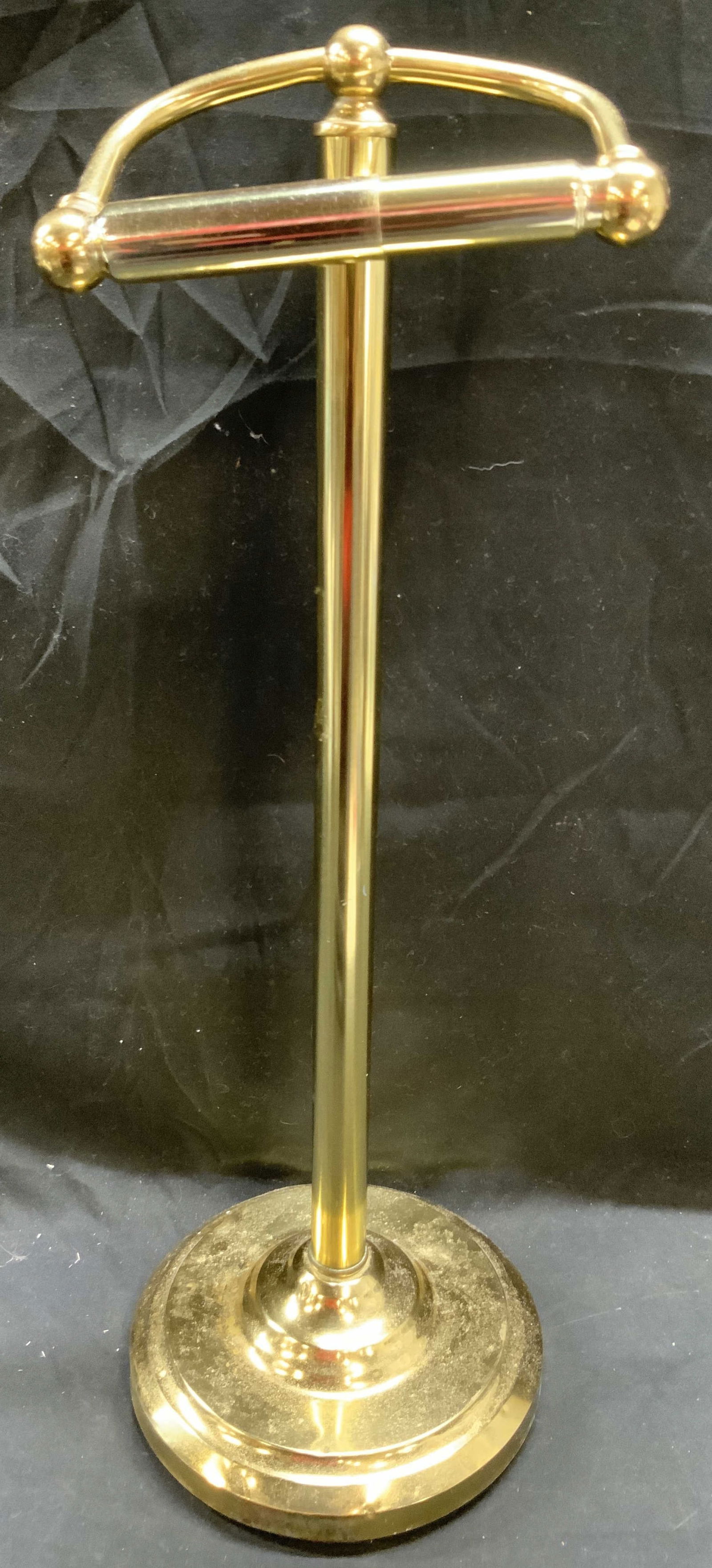 GATCO Gilt Metal Pedestal Toilet Paper Holder 22in: Underside reads GATCO. Toilet paper holder is gilt metal. Piece has circular form base. Toilet paper holder is pedestaled. Piece measures approximately 22 inches tall 7 inches diameter. Toilet paper h