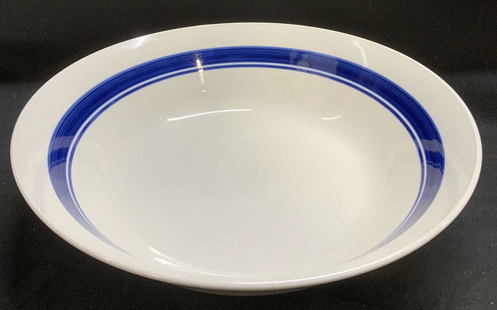 Vntg Stoneware Blue Band Serving Bowl: Vntg Stoneware Blue Band Serving Bowl Serving bowl featuring a blue band stripe & appears to be either stoneware or ceramic material. Surface wear consistent to age, use & exposure. Measurements: leng
