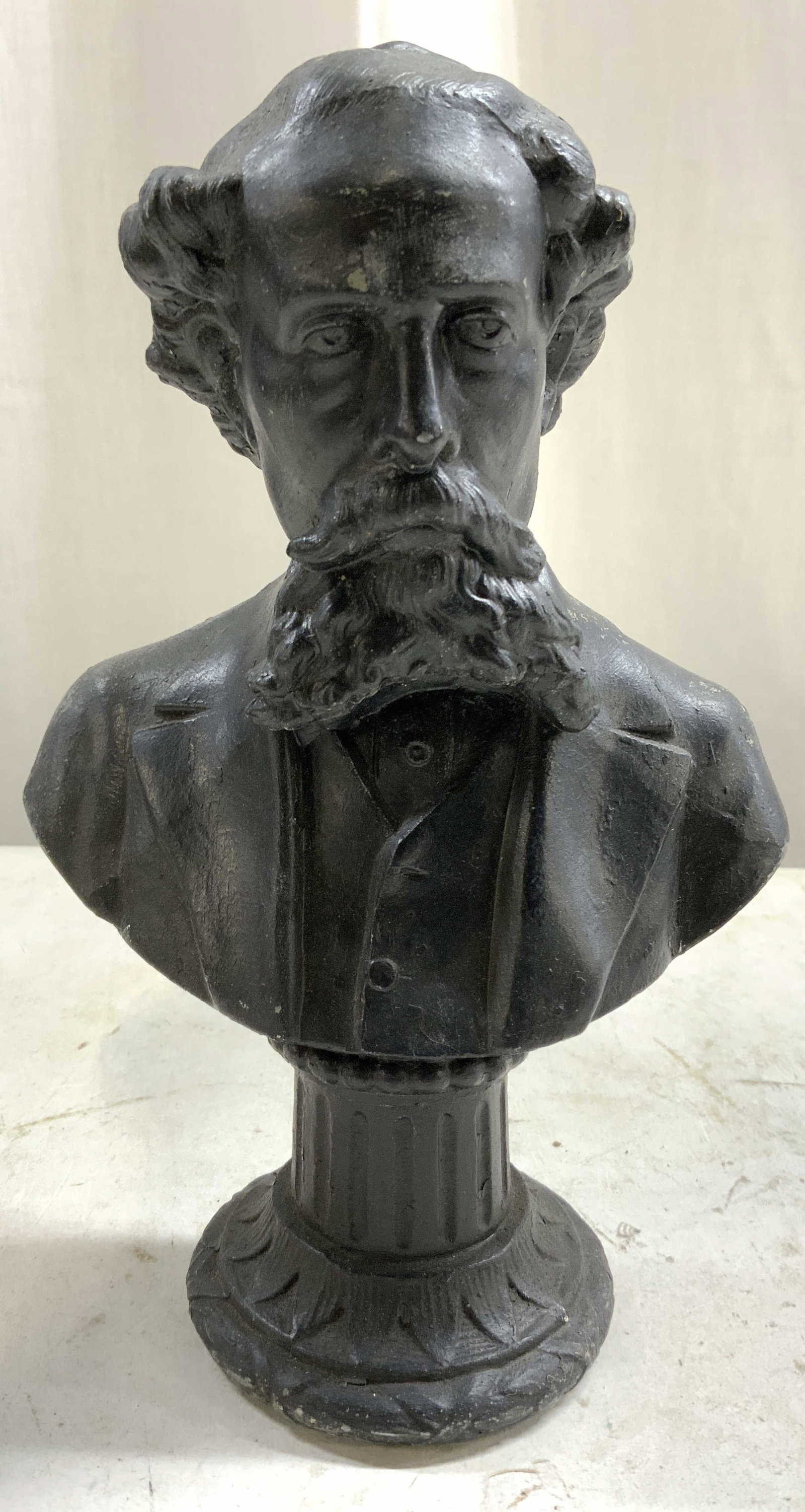 Vintage Metal Bust Of Charles Dickens 8in: Bust depicts Charles Dickens with column style base. Piece is black toned and metal. Bust has relief to show facial features and facial hair detail, in addition to detail within column. Piece measures