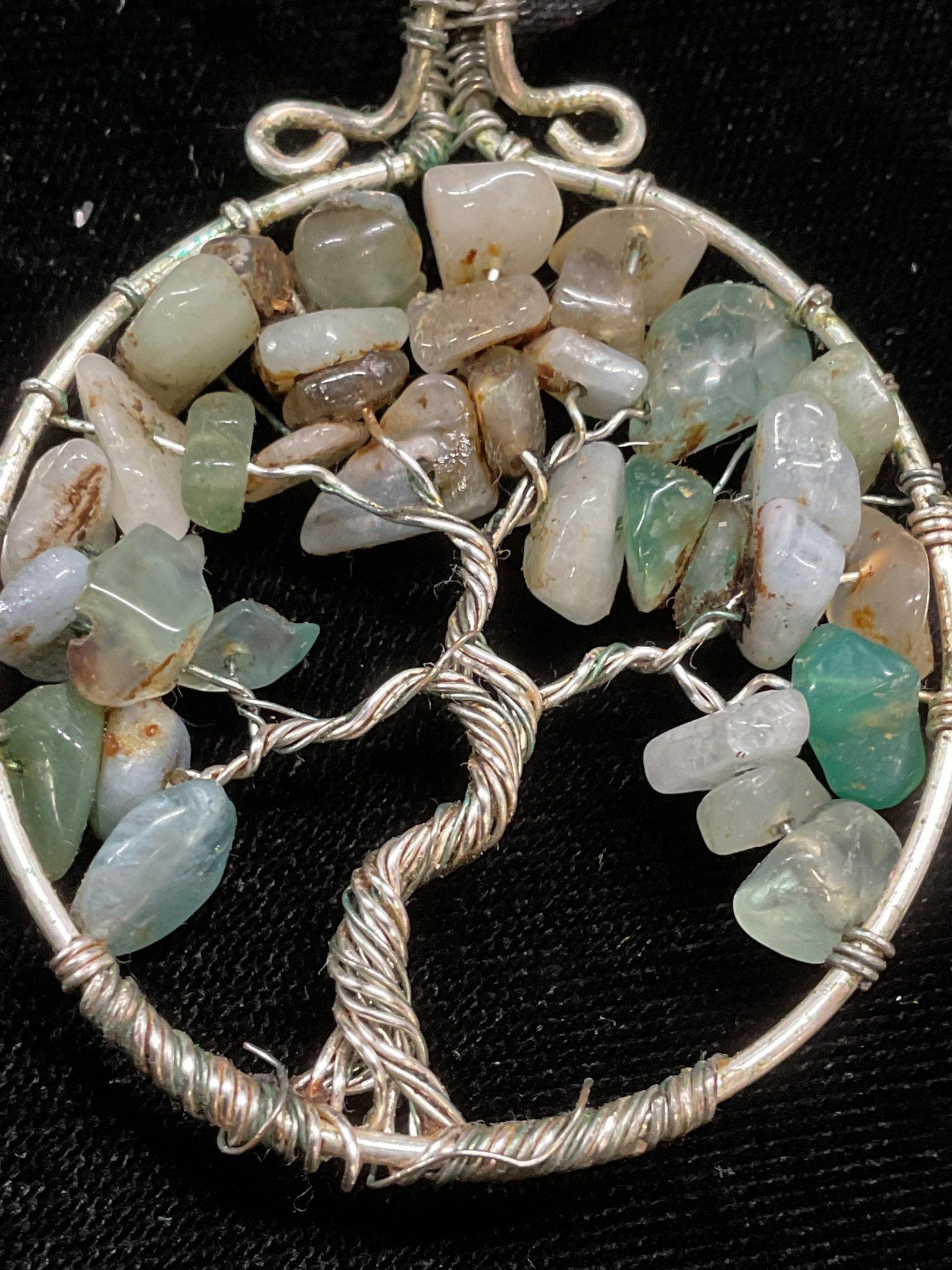 Vtg Semiprecious Stone Tree Pendant Necklace: Vintage silver tone wire tree motif pendant with green Semiprecious stones on black cord. Drop length approx 12.5 inches. Pendant approx 2 inches long. Some scratching observed. Jewelry, estate jewelr