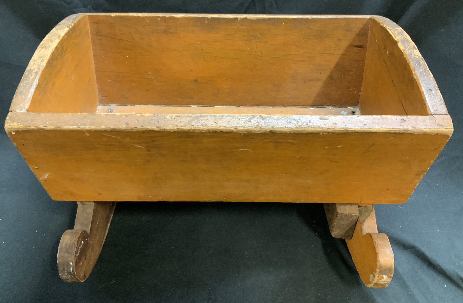Vntg Wooden Baby Doll Rocking Cradle: Vntg Wooden Baby Doll Rocking Cradle Cradle rests on two curved wooden rockers. Surface wear consistent to age, use & exposure. Measurements: length 17.6in x width 11in x height 9.6in. Wooden rocking 