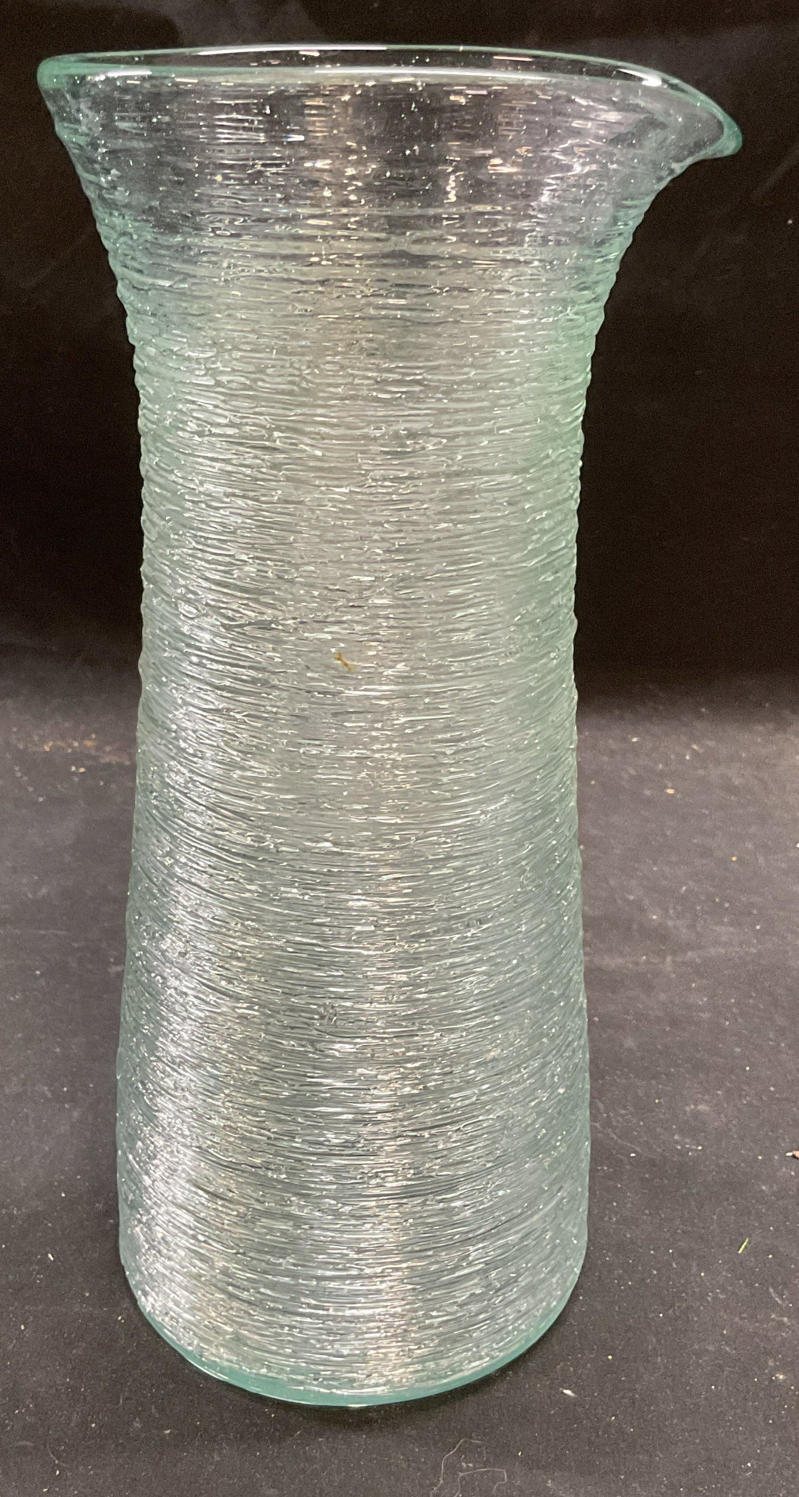 Hand Blown Spun Art Glass Carafe: Hand blown art glass carafe. Spun glass textured exterior. Thick walled glass, piece has weight. Measures approx 4.5 x 10 inches. Some wear consistent with exposure. Spun glass carafe, art glass caraf