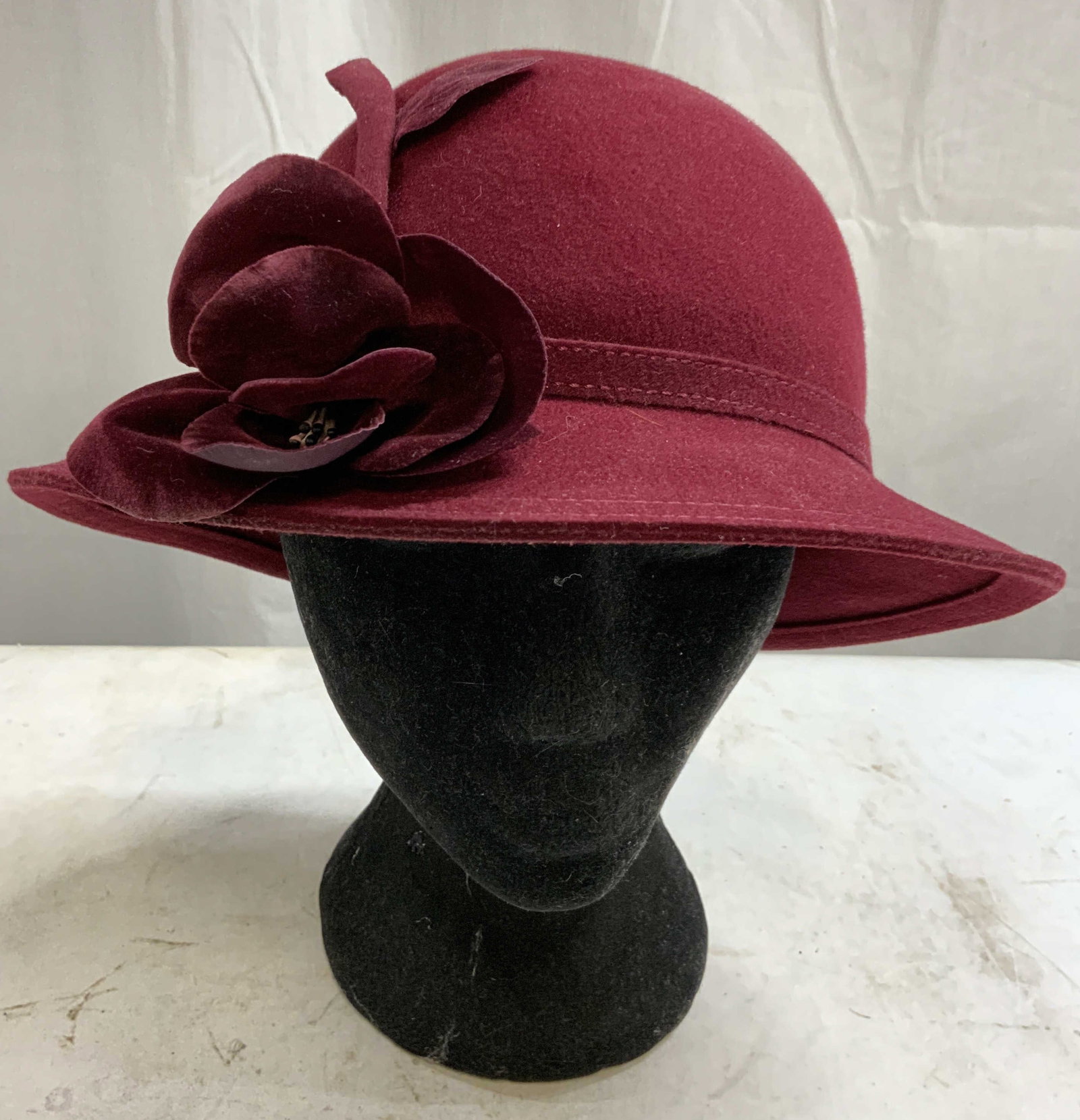 ADOLFO II EXCELLO Wool Bucket Bell Hat Wine Red US: Tag reads ADOLFO II NEW YORK PARIS. Interior marking reads EXCELLO 100% WOOL MADE IN USA GEO W BOLLMAN & CO. Hat is wine red toned and wool. Piece has floral form detail to brim. Bucket bell form hat.
