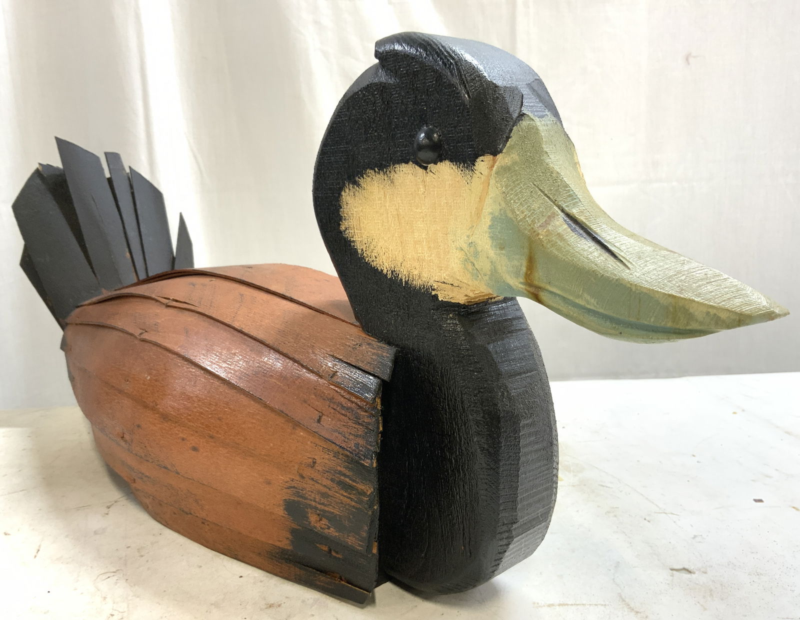 R DALIO DULONG Signed Hand Crafted Wood Duck 22in: Duck figure appears to be signed R DALIO DULONG. Piece is wooden. Duck figure appears to be hand crafted. Piece has black, brown, & white tones with light blue toned beak. Duck figure measures approxi