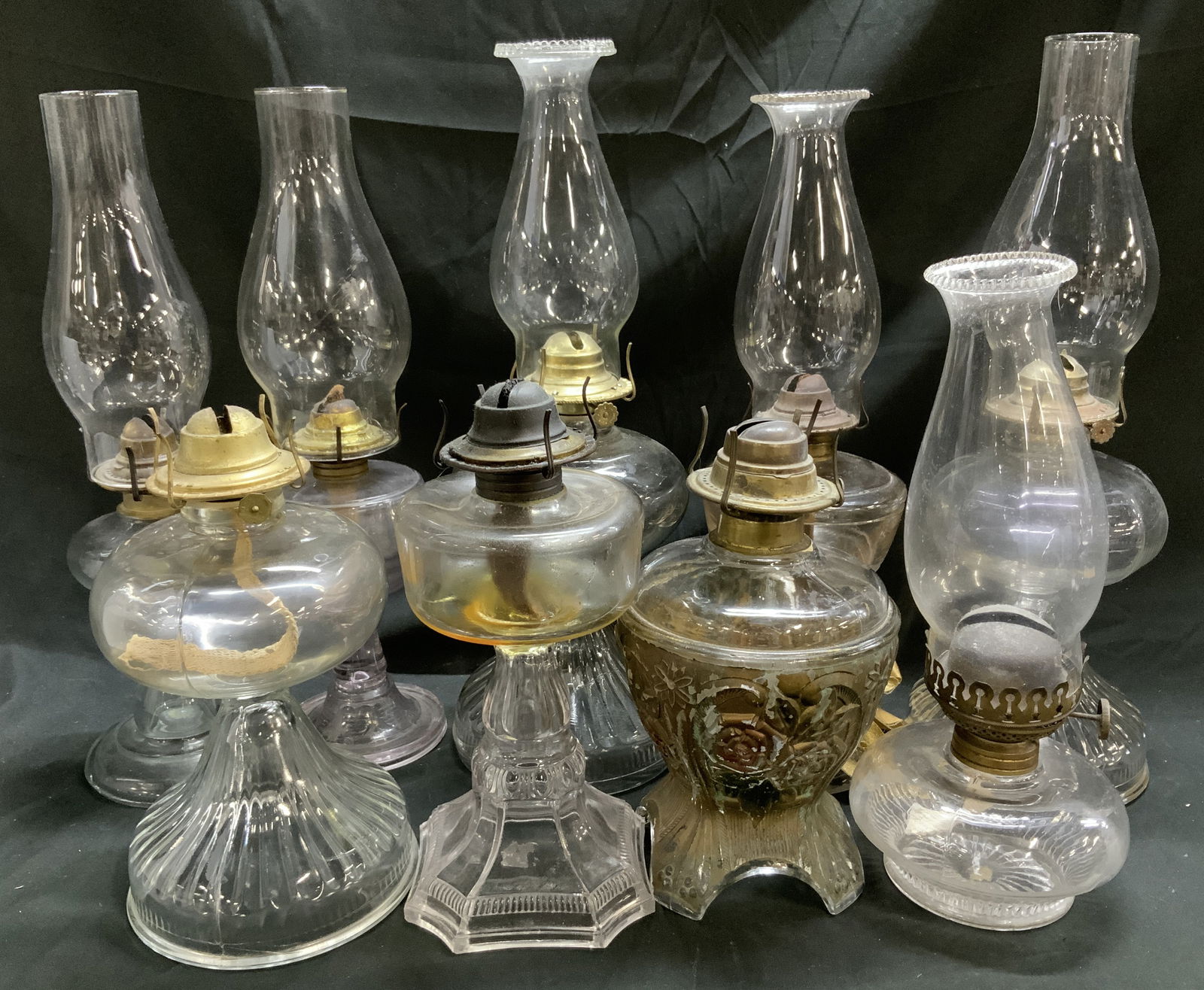 Lot 9 Vntg Glass Kerosene Oil Lamps HONG KONG: Kerosene oil lamps are made of glass & brass material. Oil lamps feature either a ribbed or fluted base. Lamps read, EAGLE, MADE IN HONG KONG, P&A MFG. CO, FARMS LAMP LIGHT. Surface wear consistent to