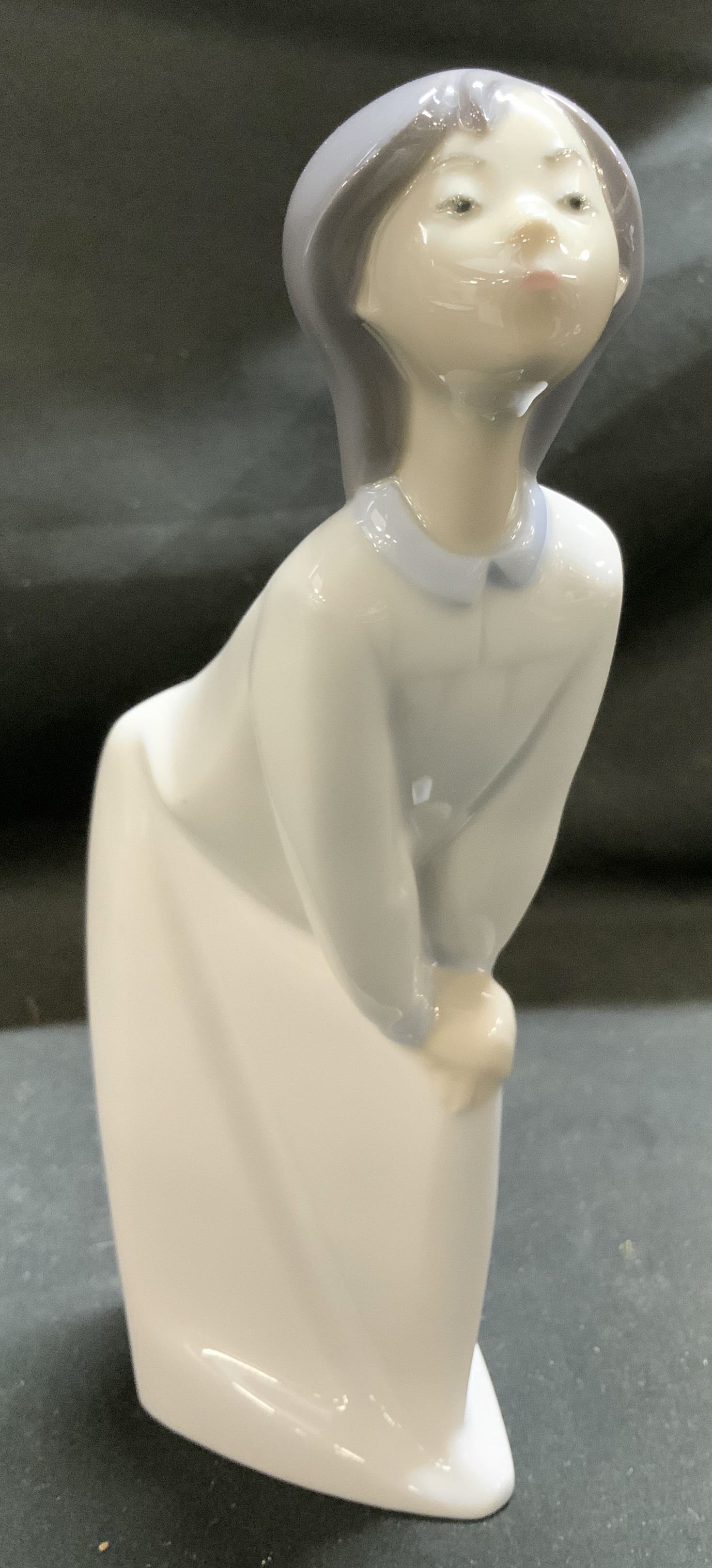 LLADRO Kissing Girl Porcelain Figurine SPAIN: Porcelain figurine depicting a young girl in a nightdress, blowing a kiss. Figurine has a glossy finish. Signed & marked on underside. Reads, LLADRO. HAND MADE IN SPAIN. Surface wear consistent to age