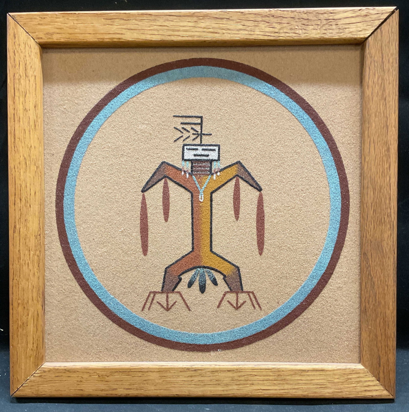 1987 Framed Signed Tribal Figure Sand Art: Framed sand art on board. Tribal style geometric figure. Signed on verso, partially legible, Steven. Dated 1987. Wood frames. Not examined out of frame. Frame measures approx 12.75 x 12.75 inches. Som