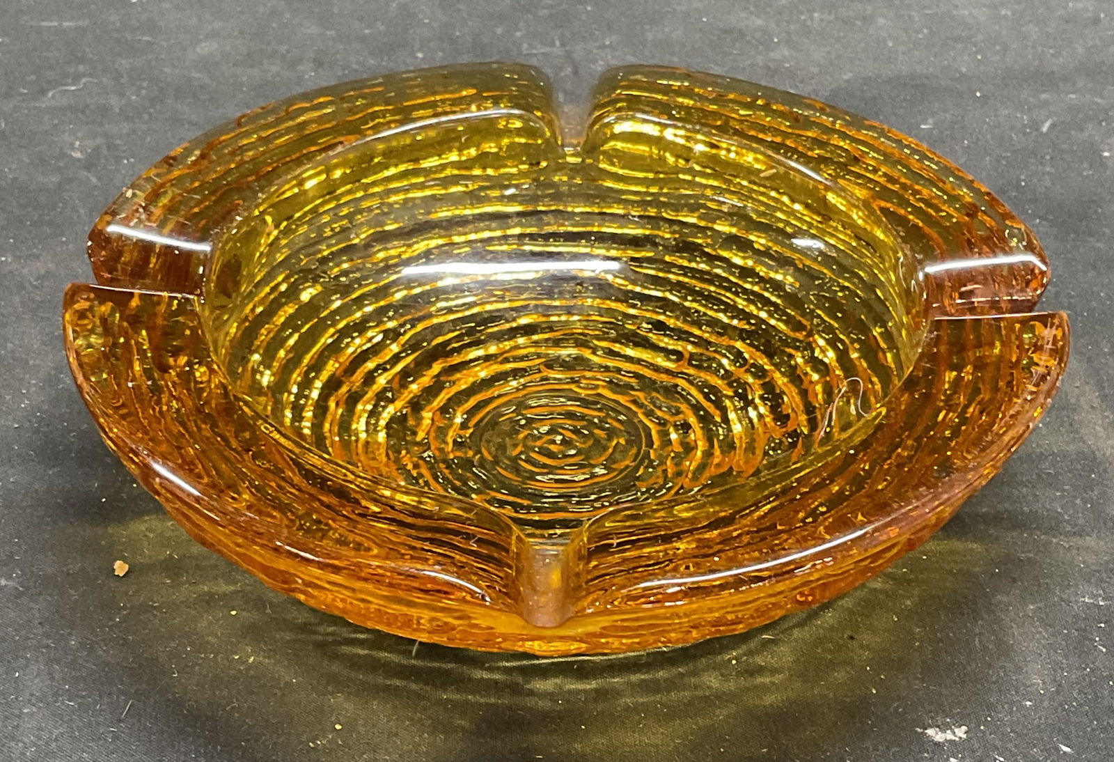 Vintage Amber Art Glass Textured Ashtray: Vintage amber tone art glass ashtray, textured surface. Measures approx 6 x 1.5 inches. Some scratching. Art glass ashtray, amber glass ashtray, vintage ashtray, ashtray, collectibles, home decor, hom