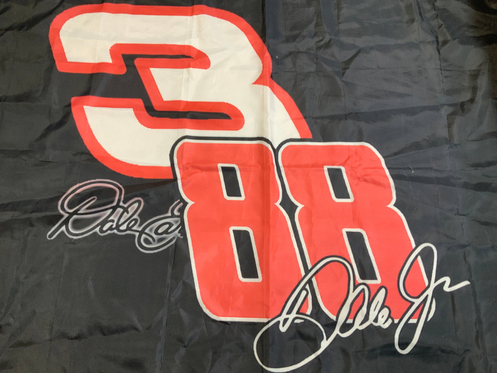 Dale Earnhardt Jr. #88 Black & Red Garage Flag: Dale Earnhardt Jr. #88 Black & Red Garage Flag Flag featuring Dale Earnhardt Jr & his #88. Flag has a black & red color. Surface wear consistent to age, use & exposure. Measurements: length 55.2in x w