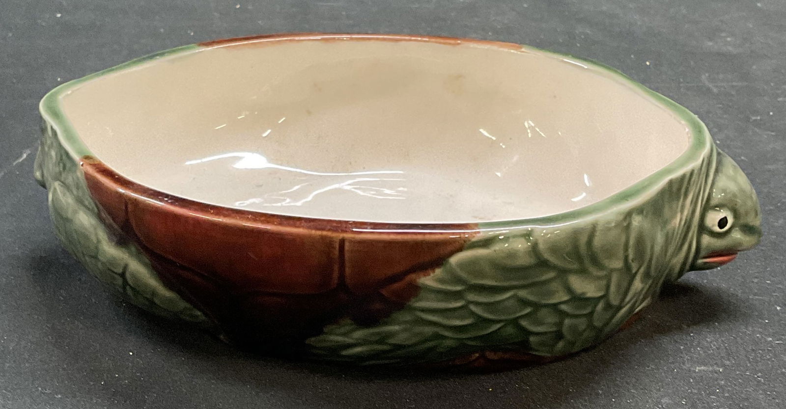 Vintage Ceramic Green Turtle Bowl, Portugal: Vintage ceramic turtle motif bowl. Hand painted green and brown. Made in Portugal. Measures approx 7 x 5.5 x 1.75 inches. Some wear consistent with exposure. Ceramic bowl, turtle bowl, turtle planter,