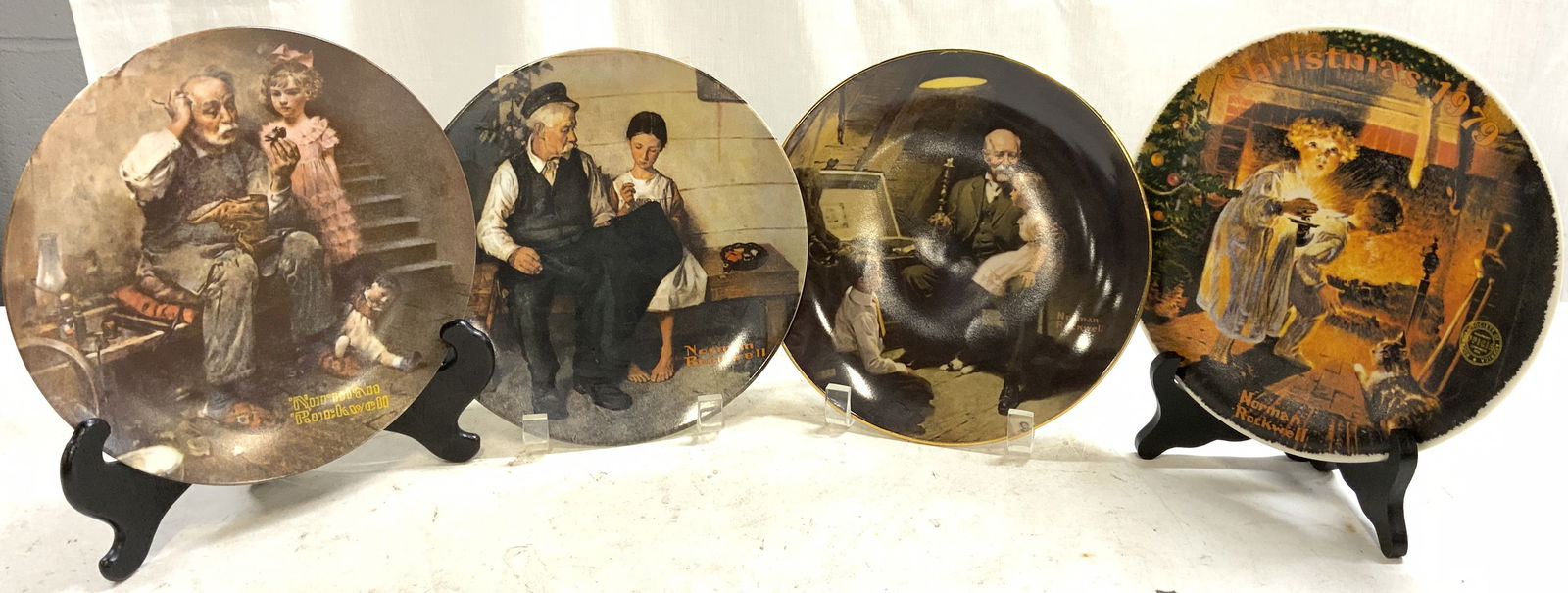 Set4 NORMAN ROCKWELL Knowles Porcelain Plates USA: Lot includes 4 plates. Each plate is trademarked NORMAN ROCKWELL. Each are vintage and porcelain. Lot includes plate number 129174 The Lightkeepers Daughter, 562H The Cobbler, 14,567E Somebodys Up The