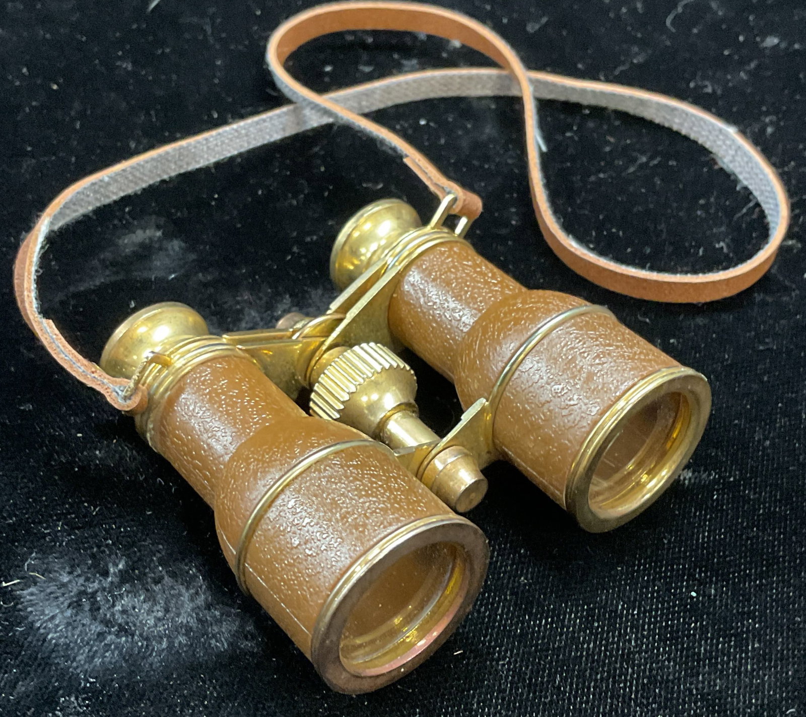 Miniature Gold Tone Brown Binoculars: Miniature binoculars, gold tone metal and brown composite material. Magnified lenses. Measures approx 2.25 x 2 inches. Some scratching. Binoculars, magnifying lenses, brown binoculars, gold tone binoc