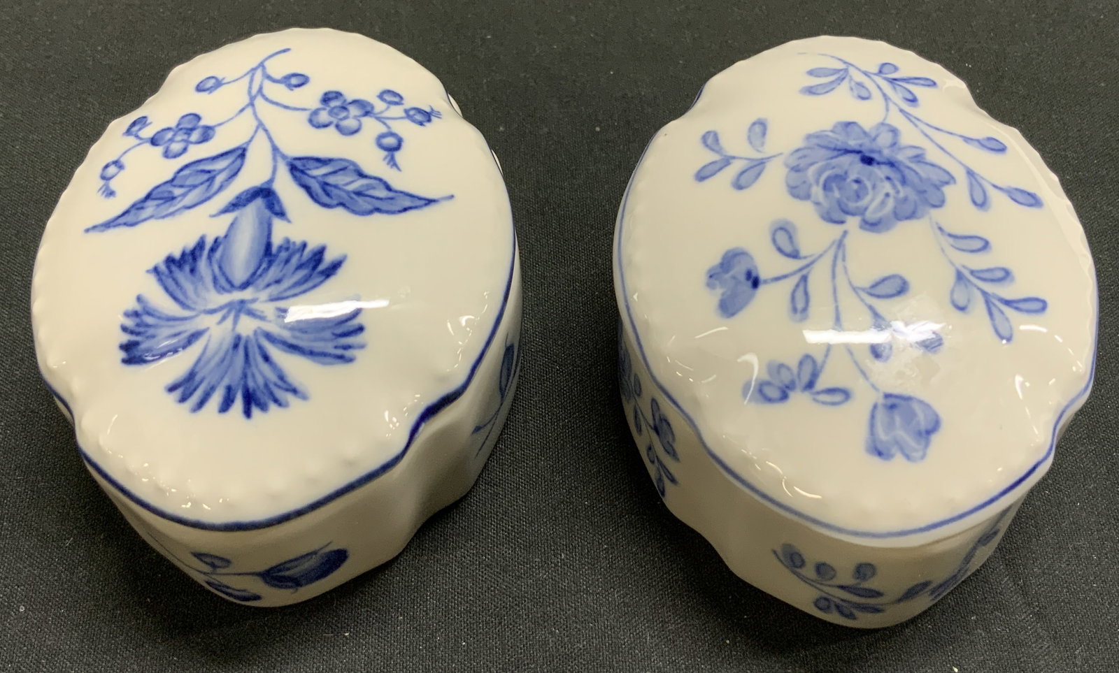 Lot 2 Andrea By Sadek Blue in Bloom Trinket Dishes: Lot includes, 2 Andrea by Sadek trinket dishes. Trinket dishes feature white with blue floral designs & a scalloped edge. Signed & marked on underside. Reads, Blue In Bloom. Williamsburg. Andrea by SA